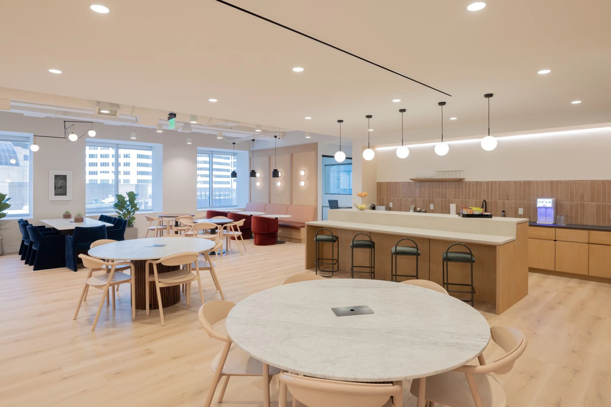 A spacious coworking workspace furnished with a table and chairs for collaborative meetings.