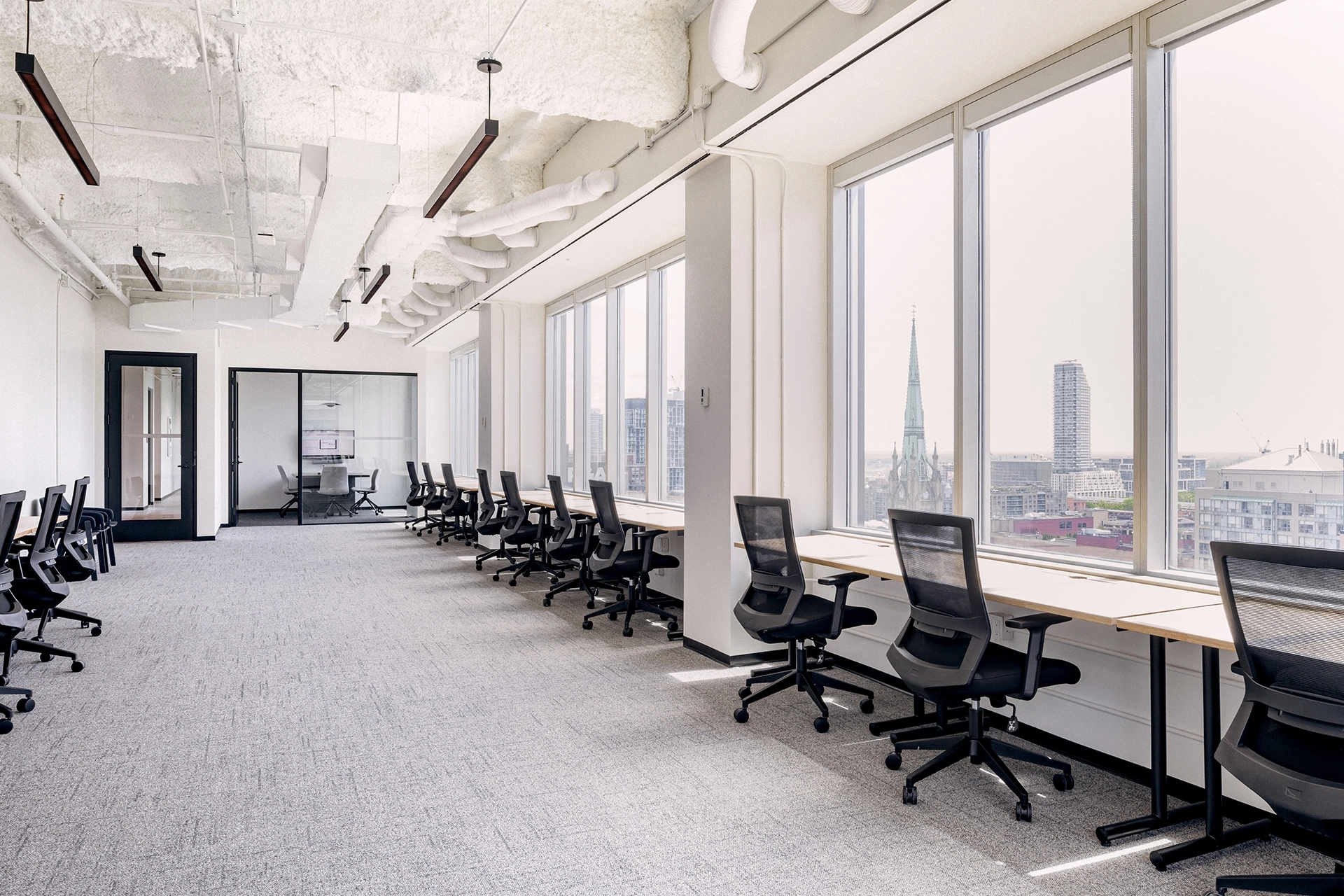 An expansive Toronto office equipped with numerous desks and chairs.
