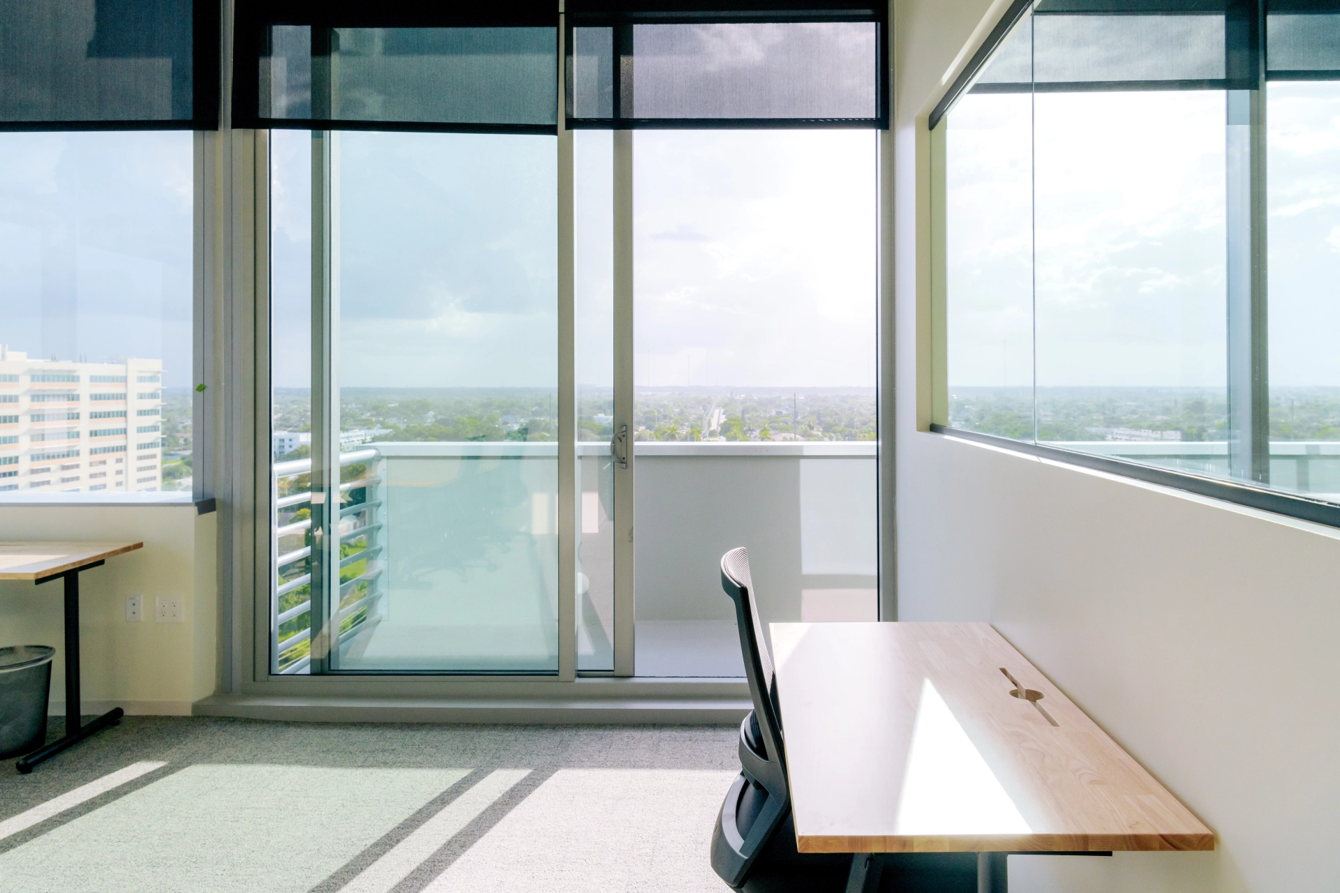 A coworking desk in a meeting room with a view of Hallandale Beach.