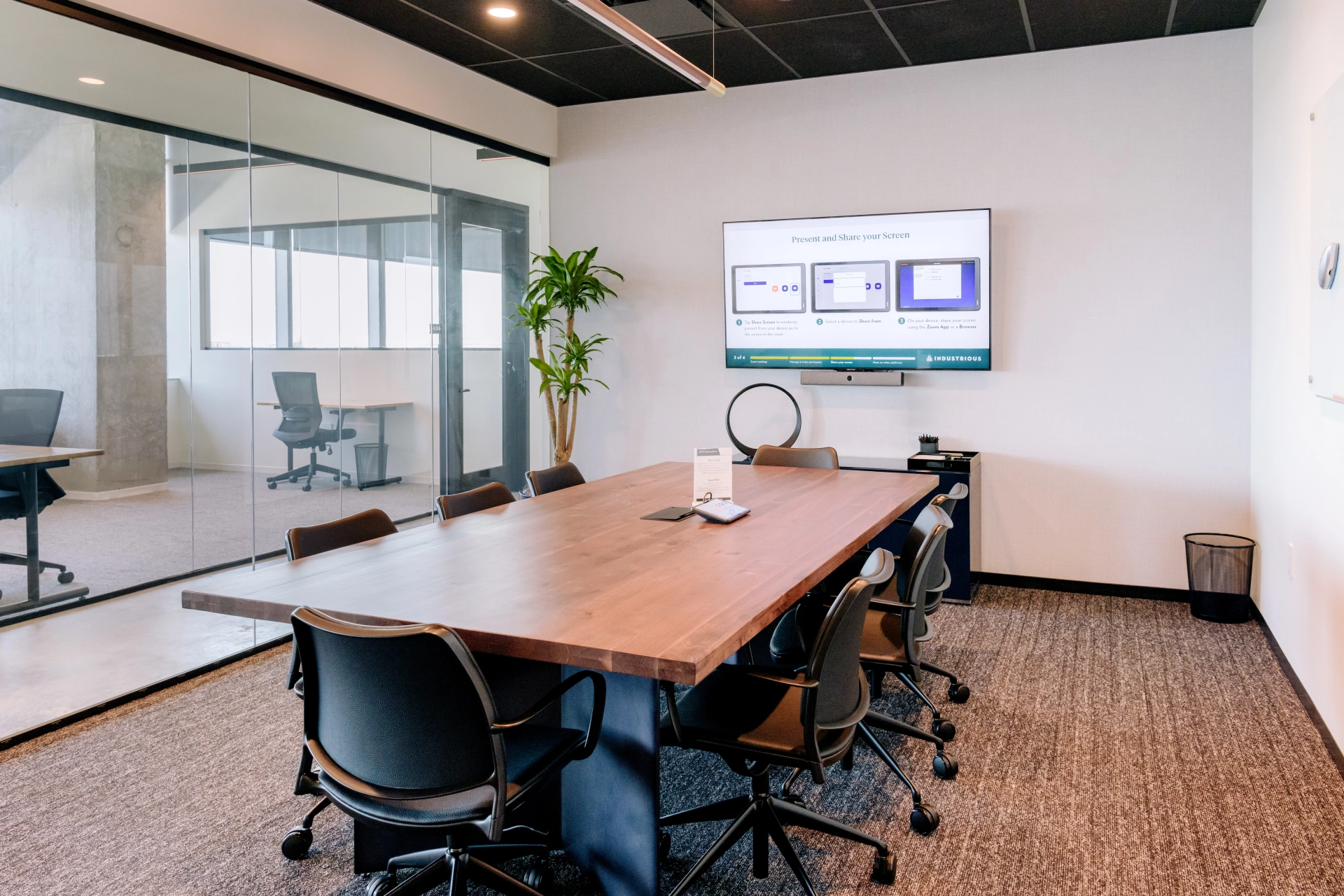 An office meeting room equipped with a large screen TV.