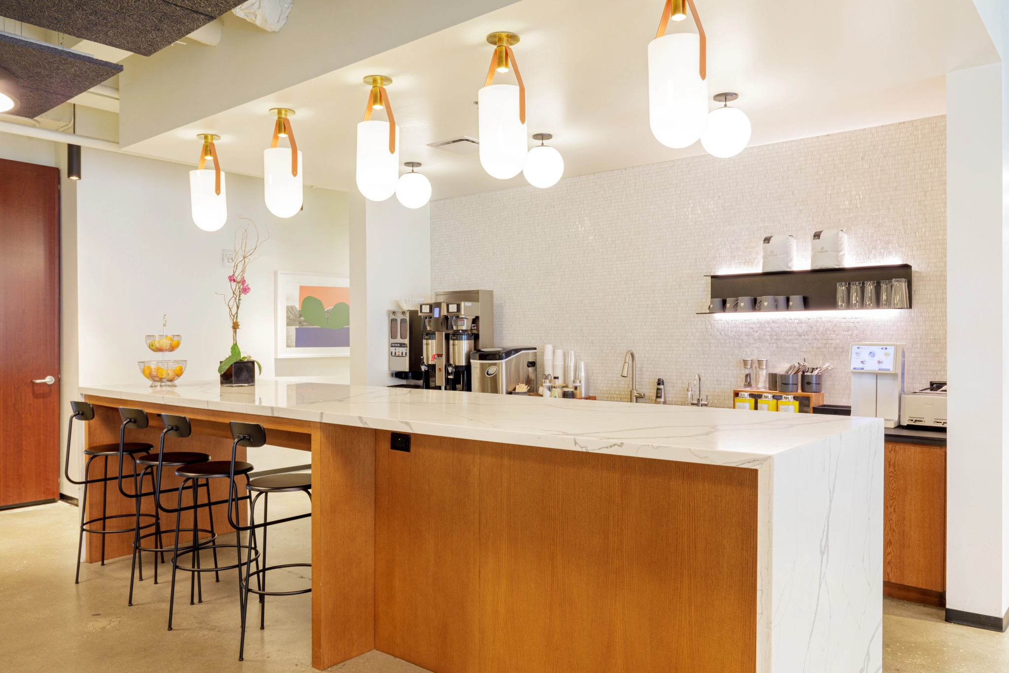 a coworking space with bar stools and a counter in Orlando.