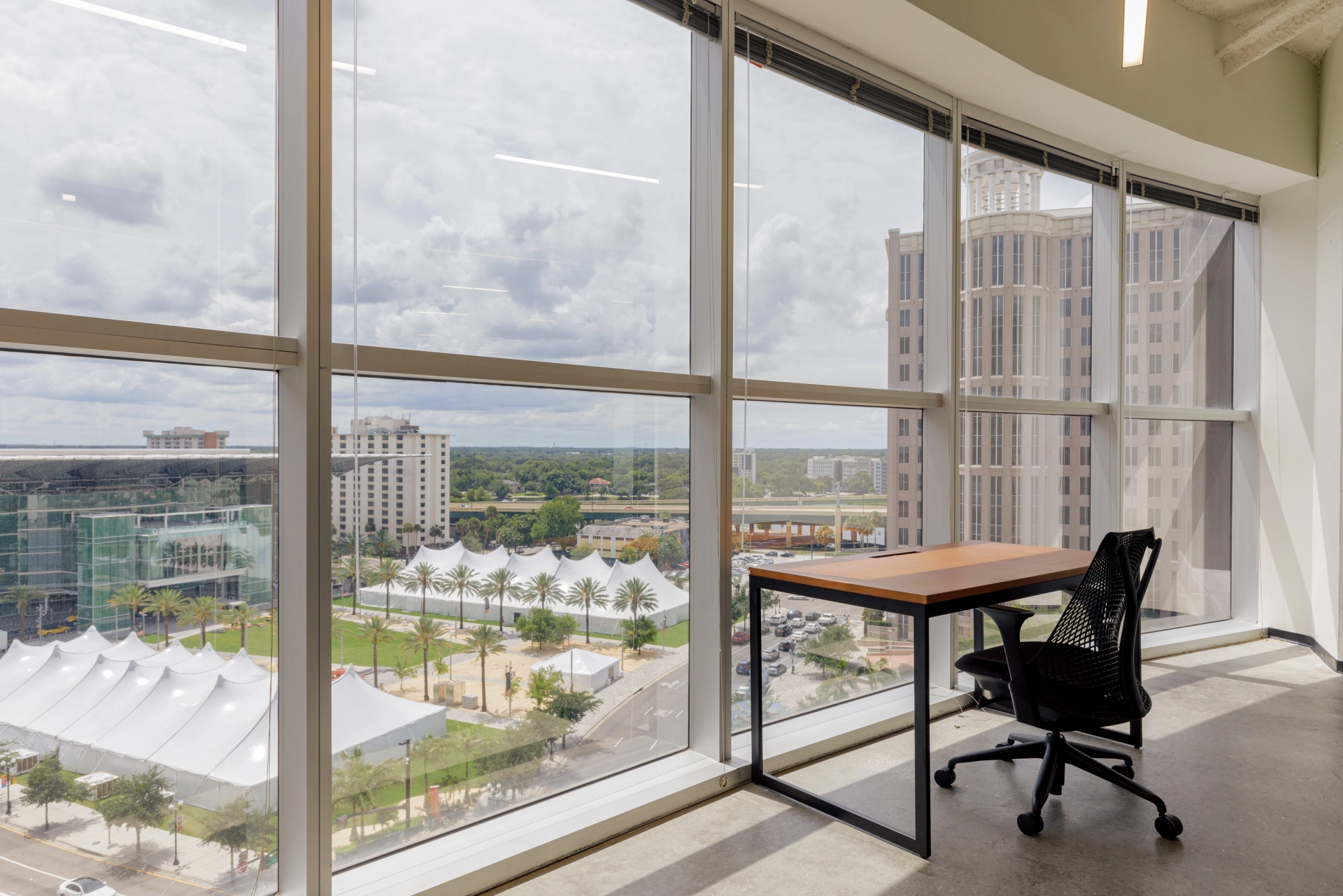 A meeting room in Orlando with a large window overlooking the city.