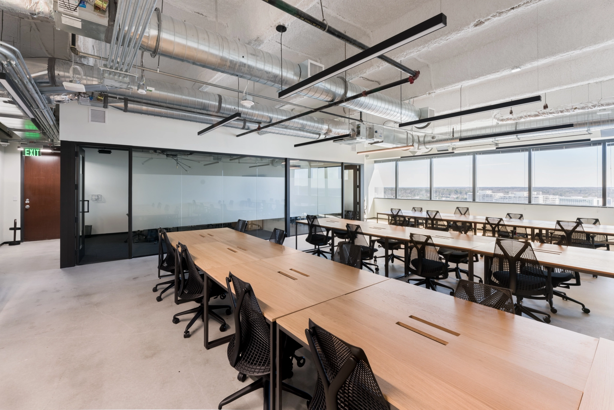 A spacious meeting room in Atlanta equipped with tables and chairs.