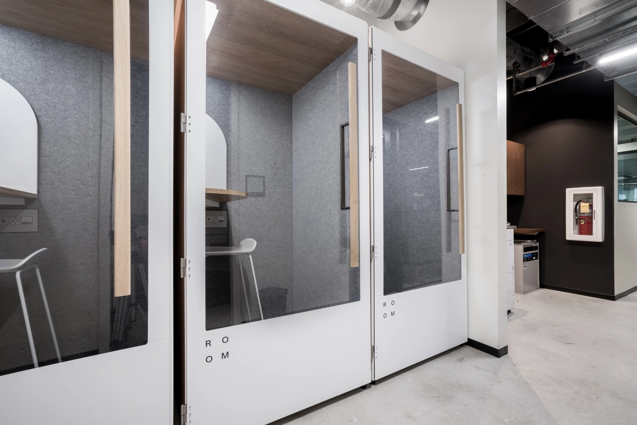 A white workspace in Atlanta with a glass door and a desk.