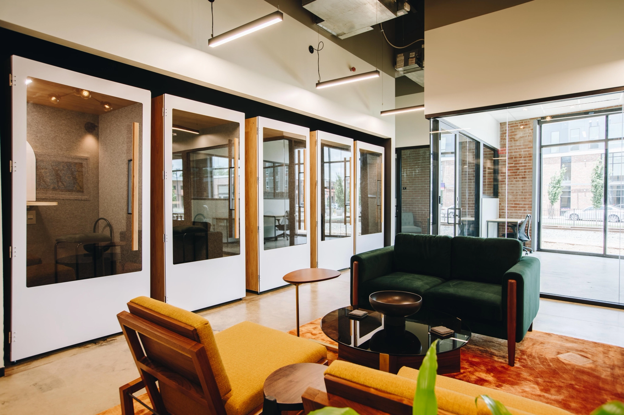 A coworking office with glass walls and chairs.