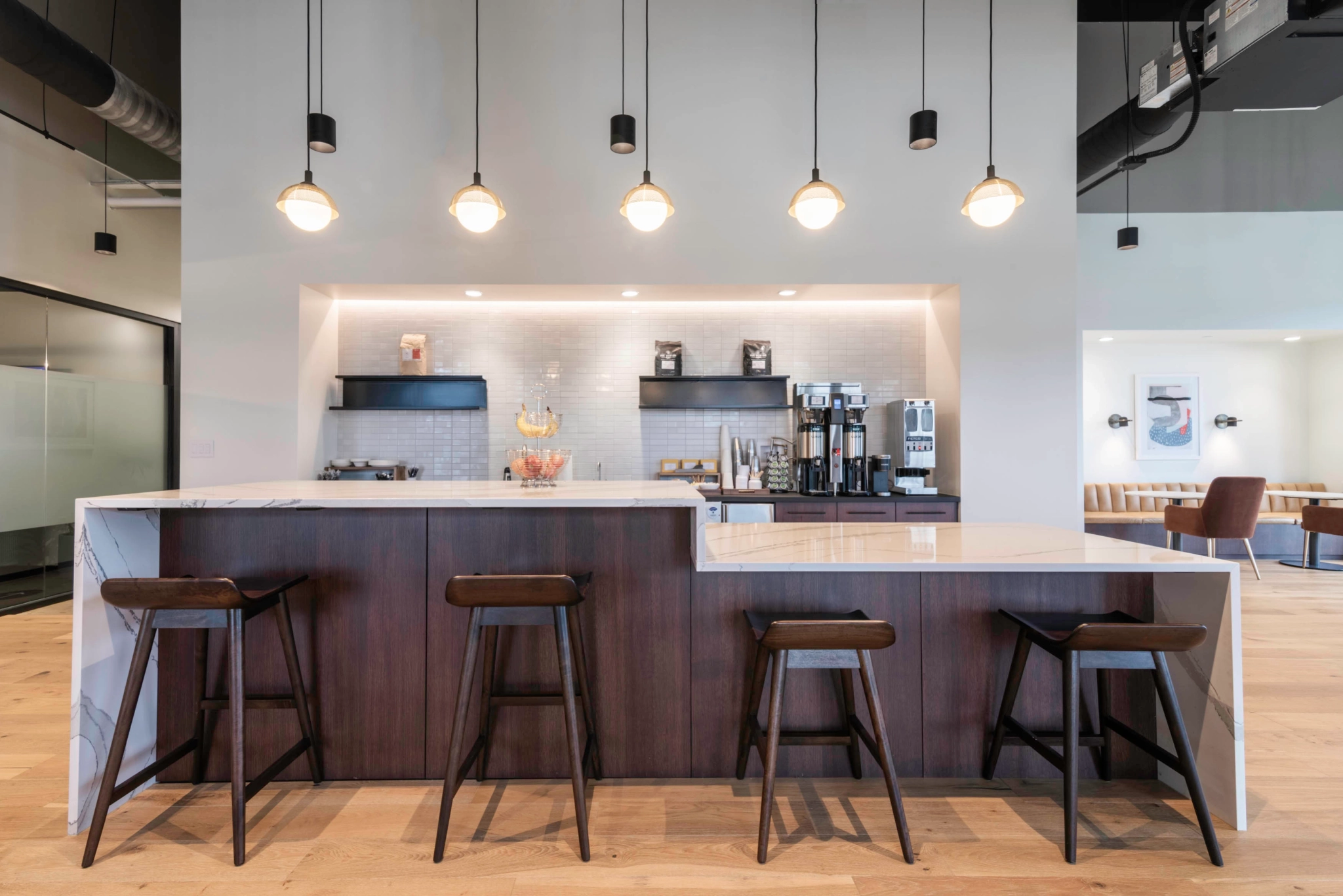 A coworking space with a bar and stools.