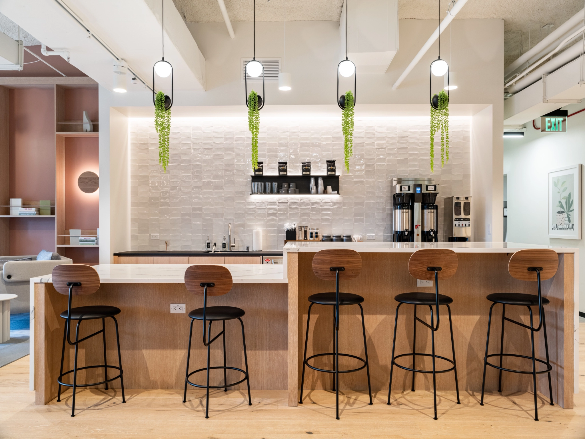 A modern coworking office in Concord with a bar and stools.