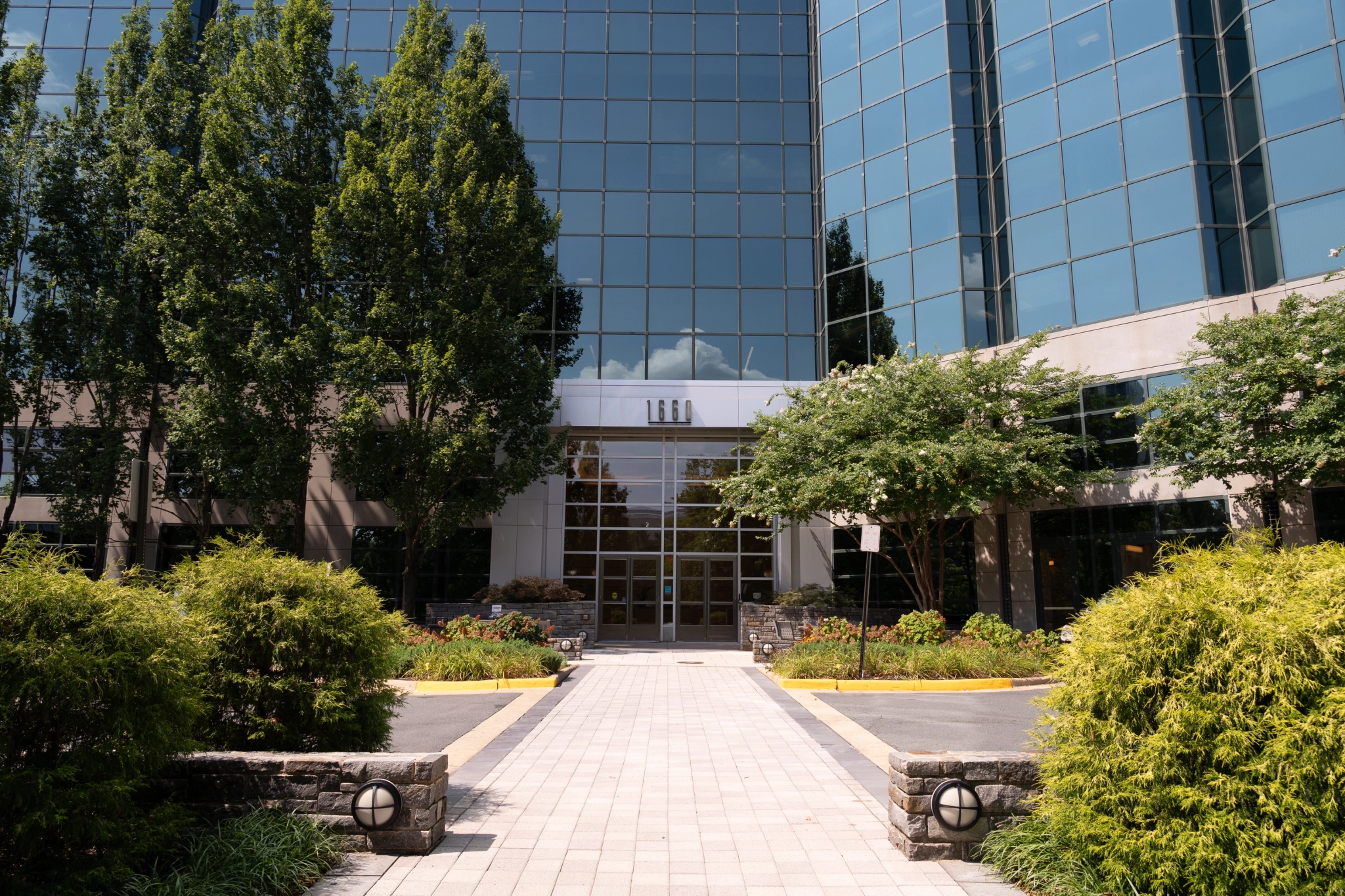 A spacious meeting room with floor-to-ceiling windows located in a large glass building in McLean.