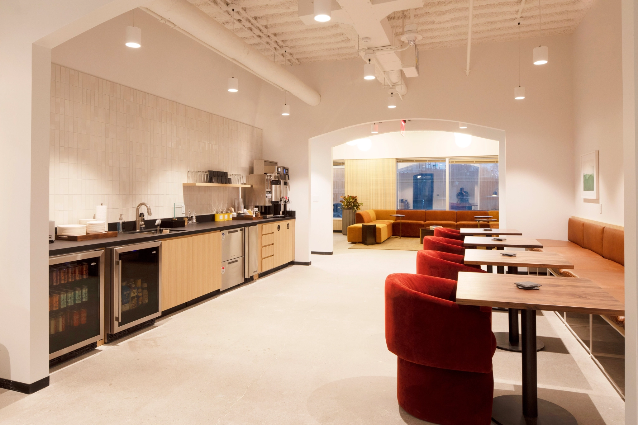 An office space in Pittsburgh featuring red chairs and a counter.