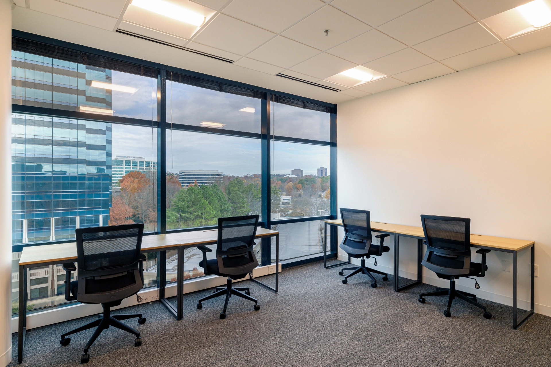 A coworking office in Atlanta with two desks and a window overlooking the city.