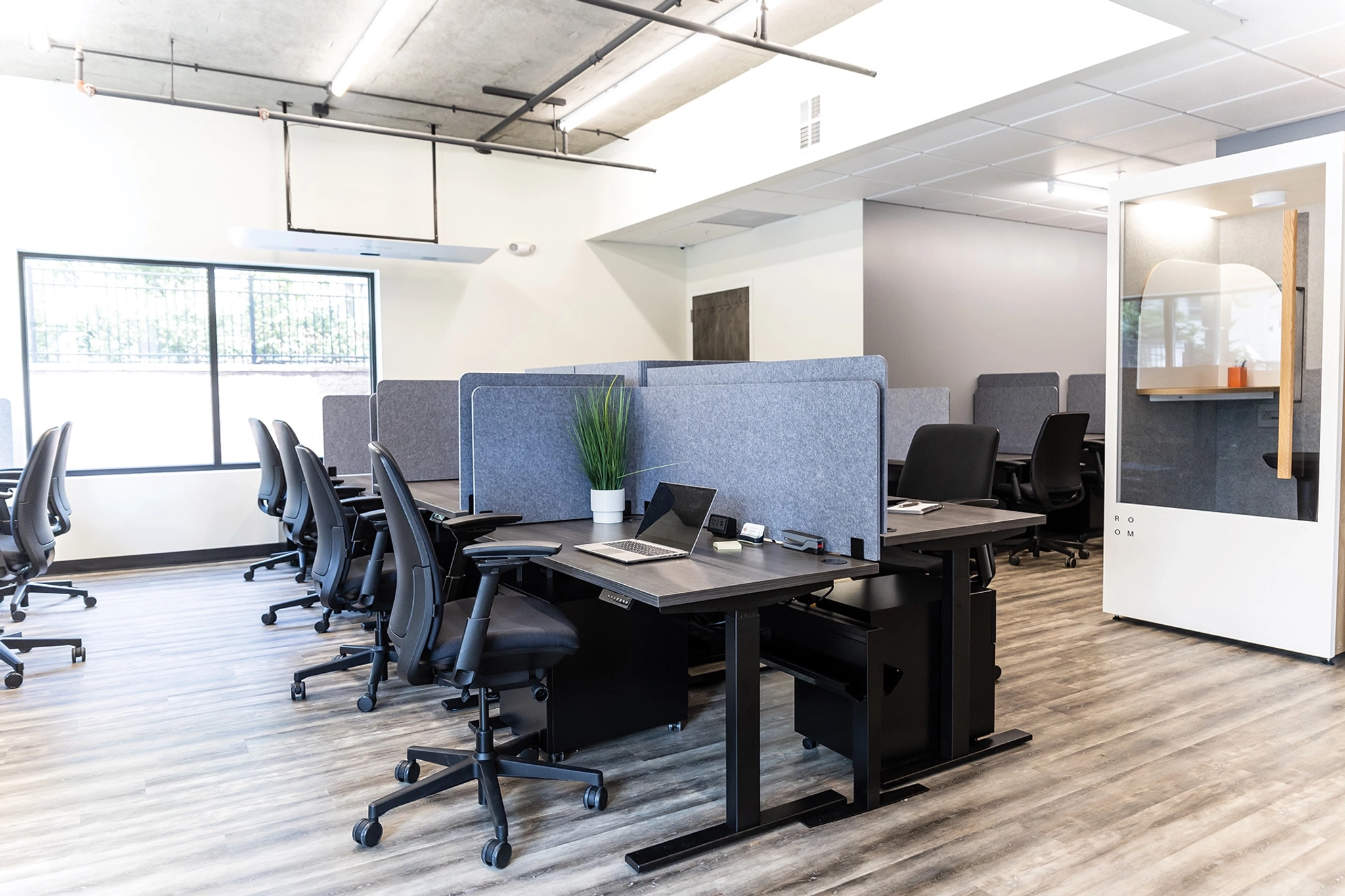 A Maplewood office with workspaces consisting of desks and chairs.