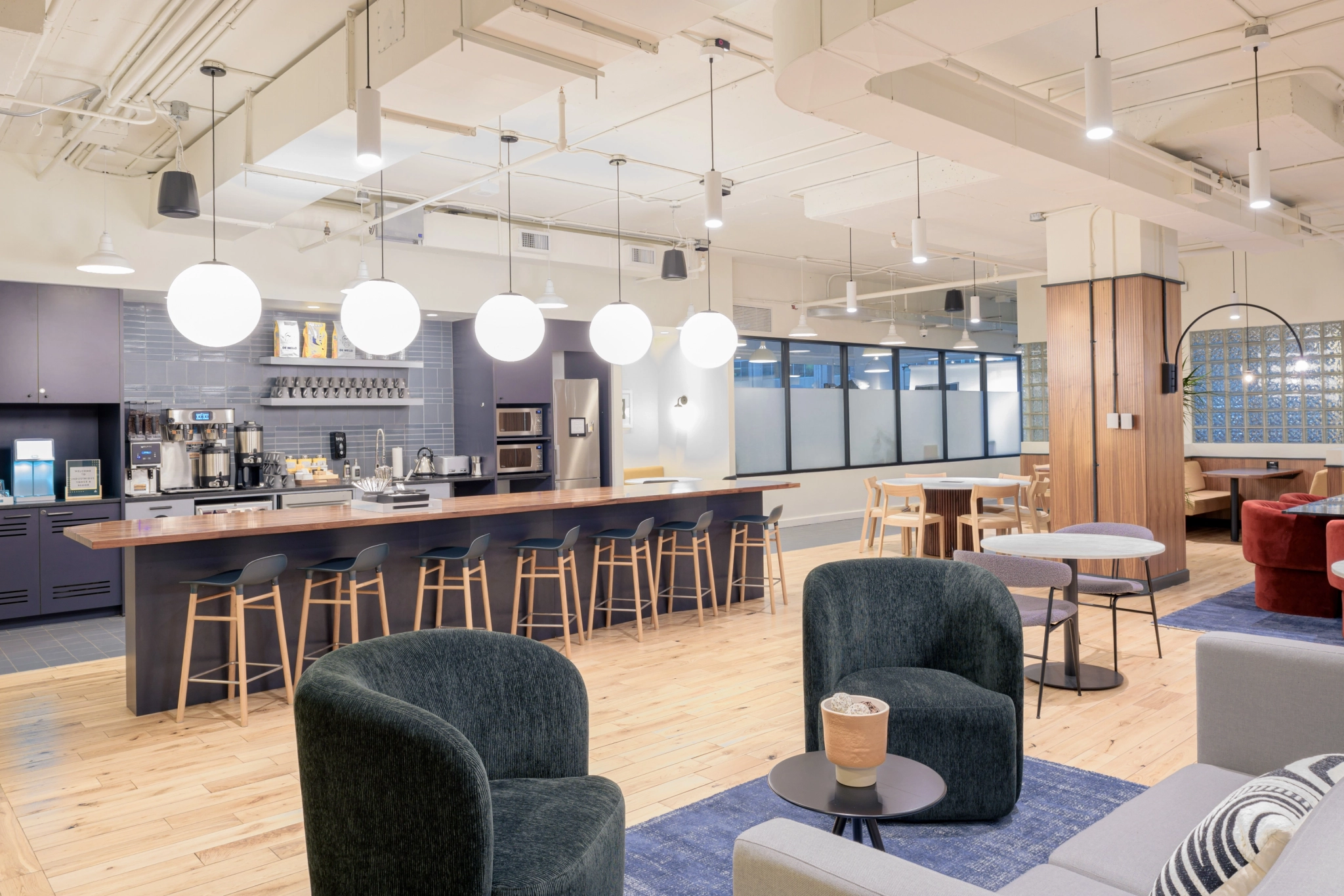 A modern coworking space in Toronto with a bar and couches.