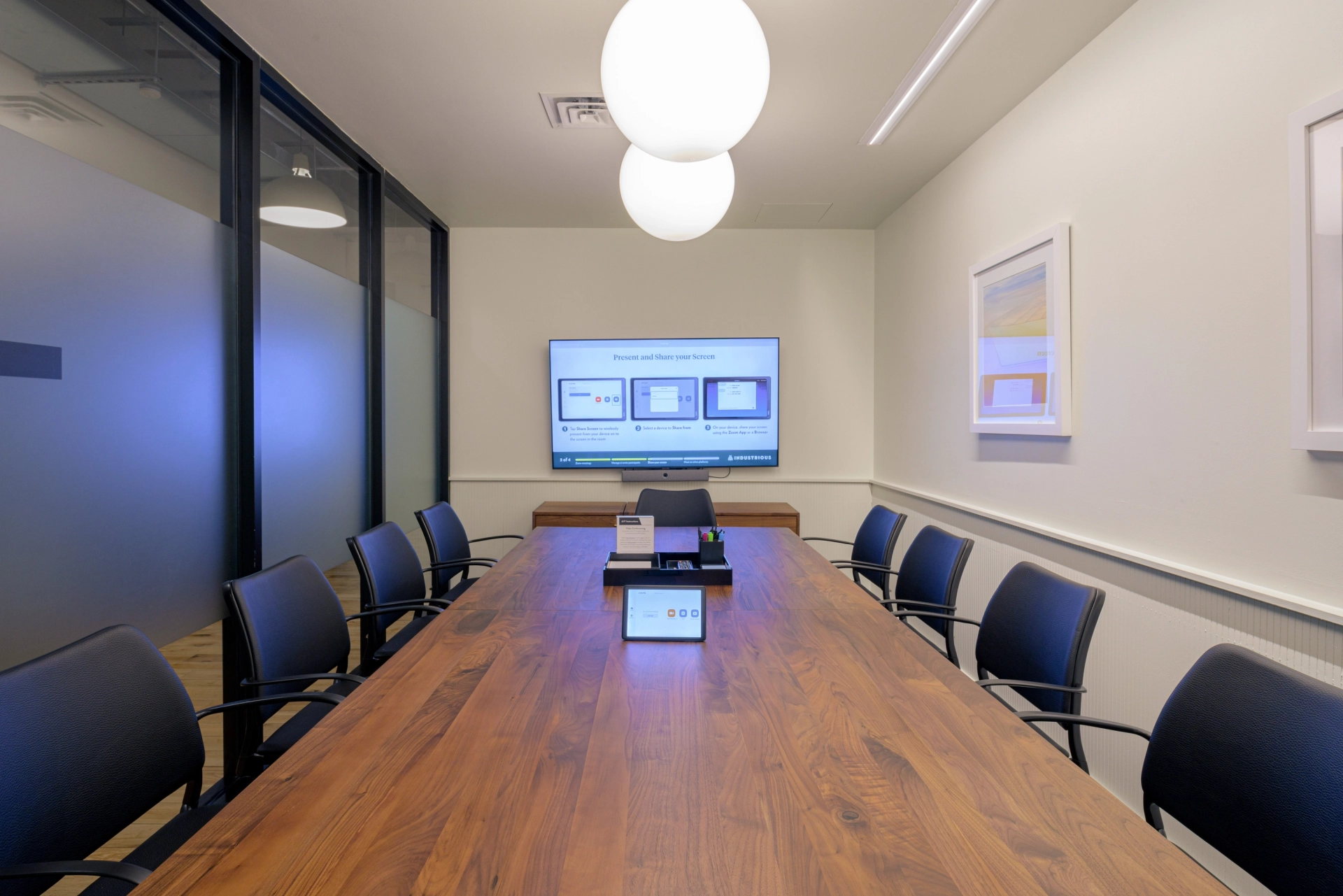 a meeting room with a wooden table and chairs.