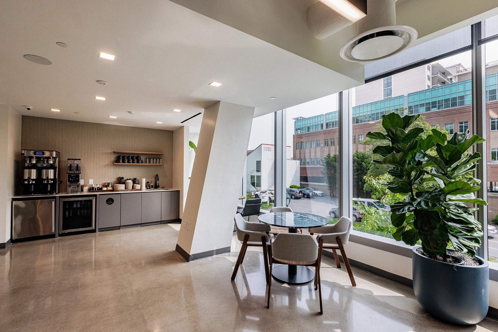 A coworking area in Bethesda with a large window overlooking the city.