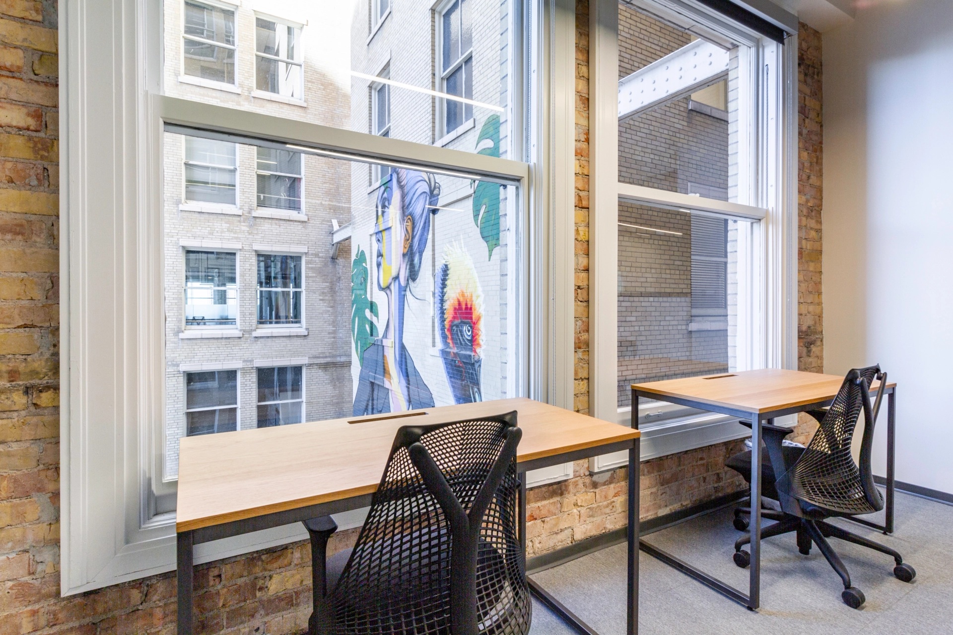 Salt Lake City office with a window providing a spacious workspace for two desks.