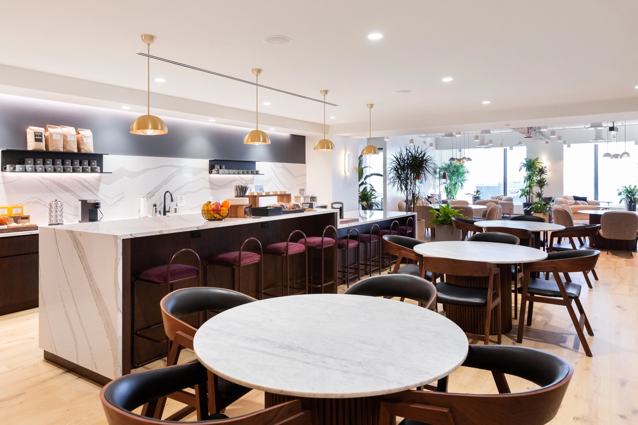 A Chicago restaurant with tables and chairs, featuring a marble counter for coworking or meetings.