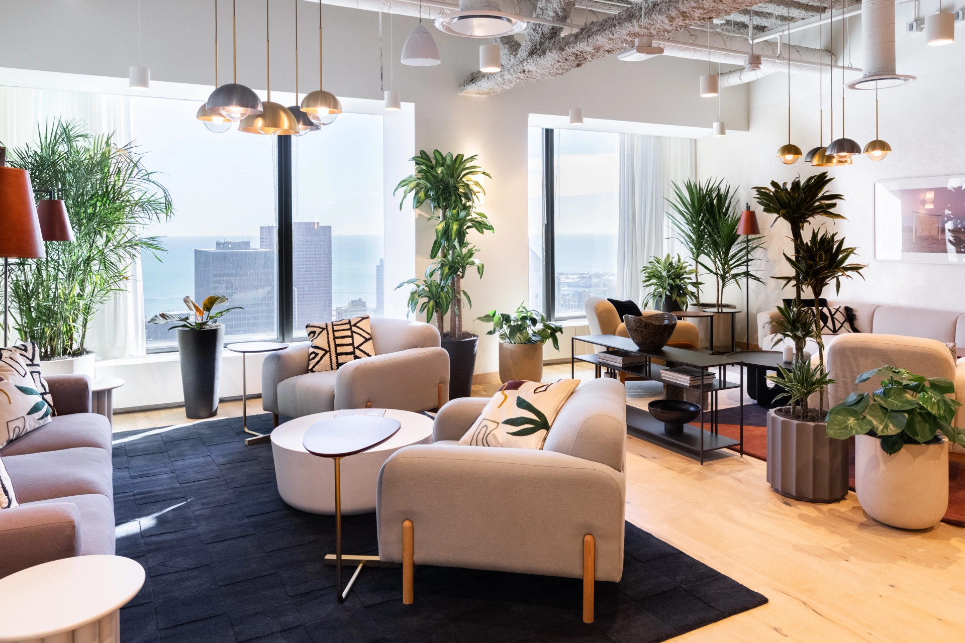 a coworking workspace in Chicago with lots of plants and furniture.