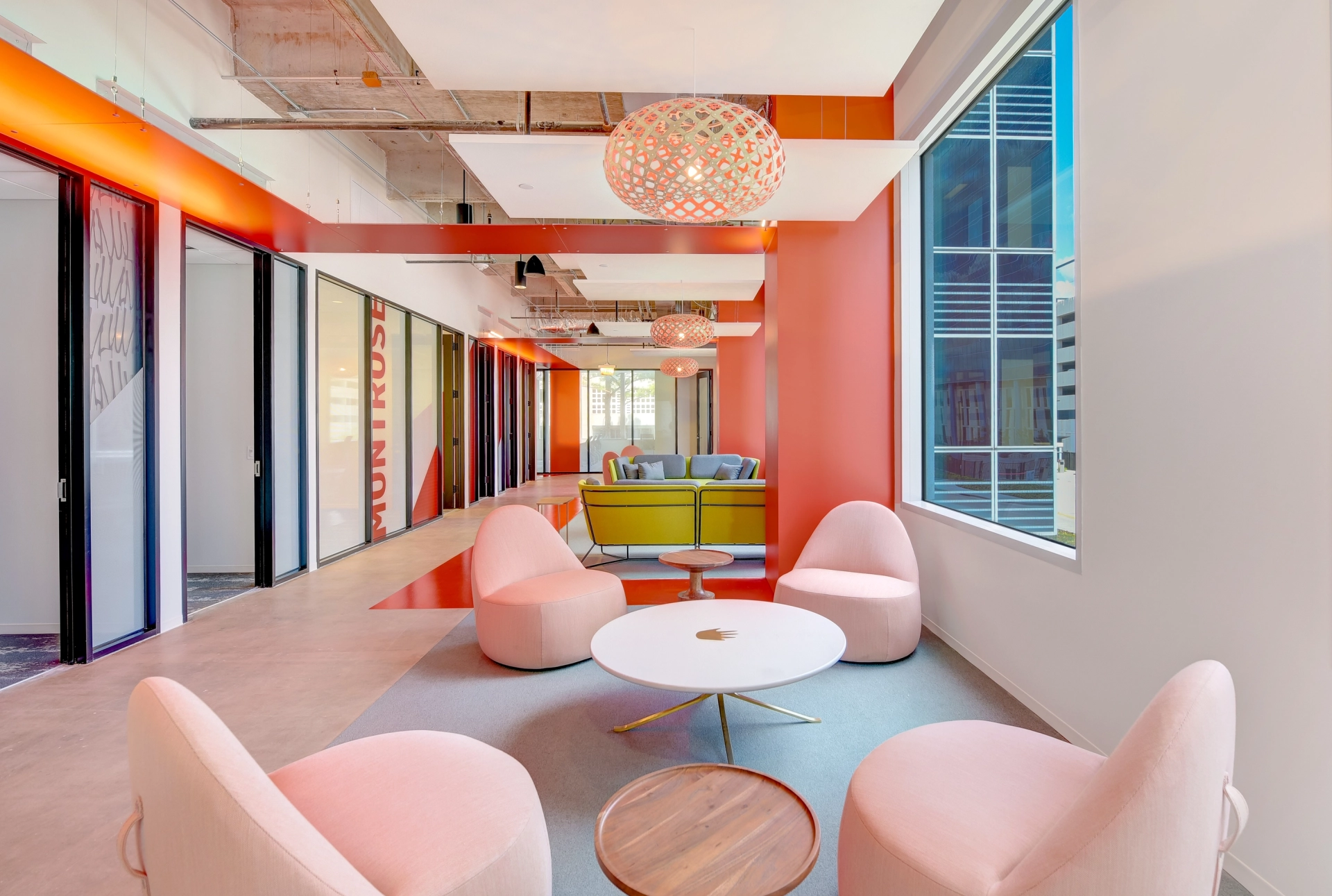 A vibrant coworking space in Houston with brightly colored chairs and tables.
