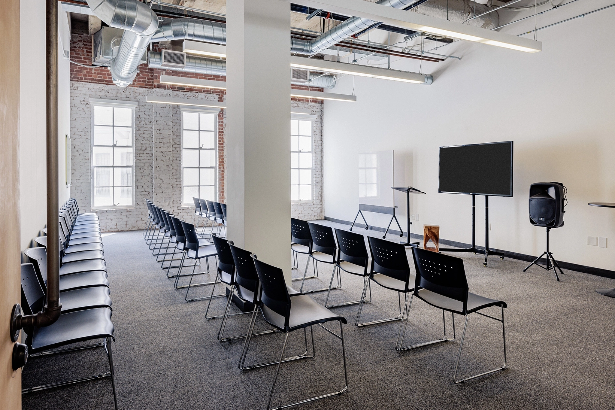 A San Francisco meeting room with rows of chairs and a TV.