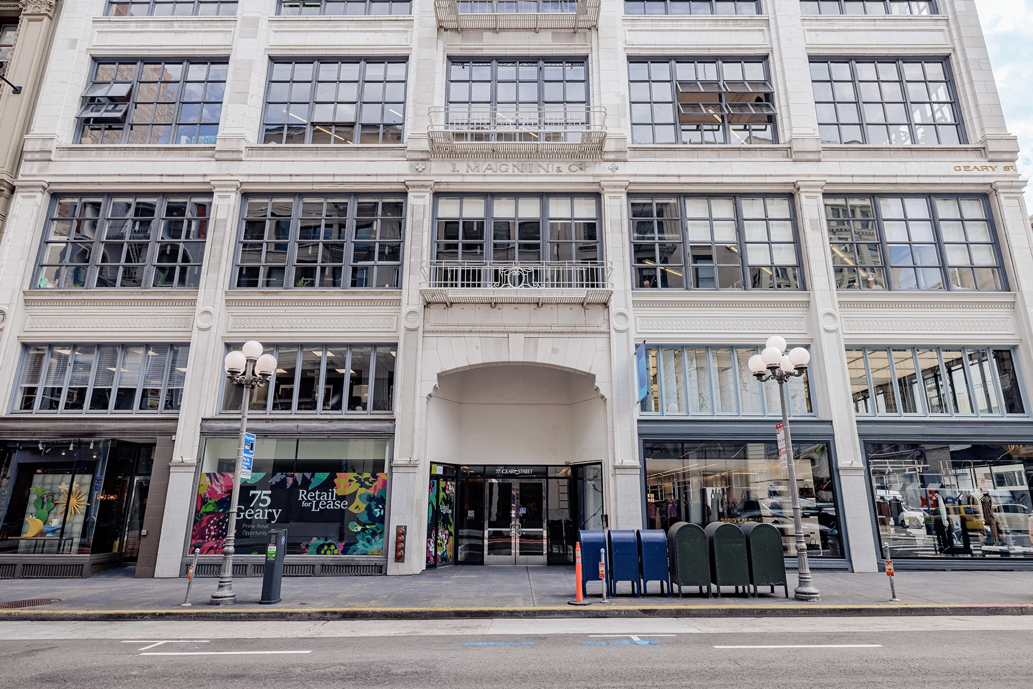 A large white building with many windows in San Francisco offering coworking and meeting room spaces.