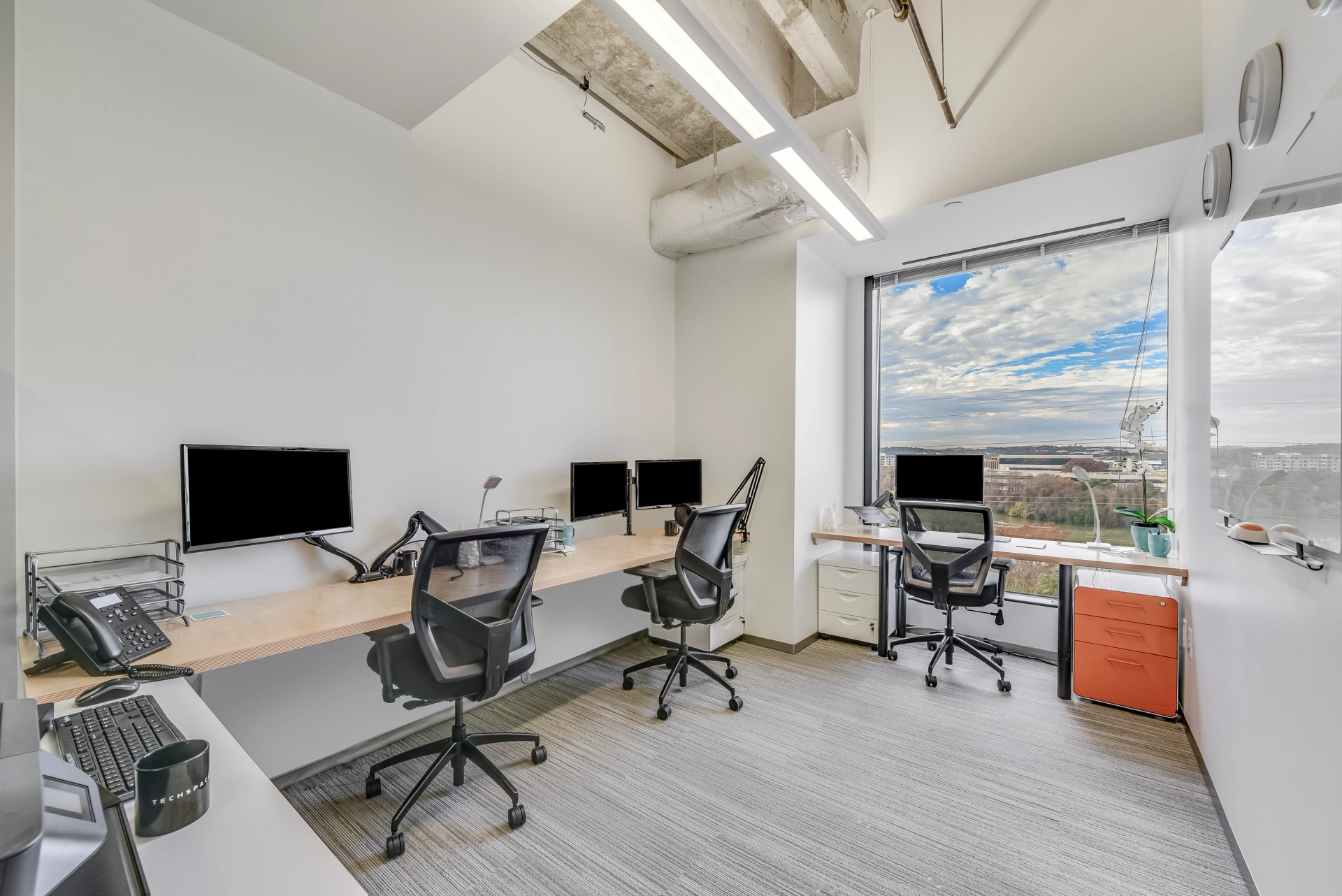 a coworking office with a large window overlooking the city of Austin.