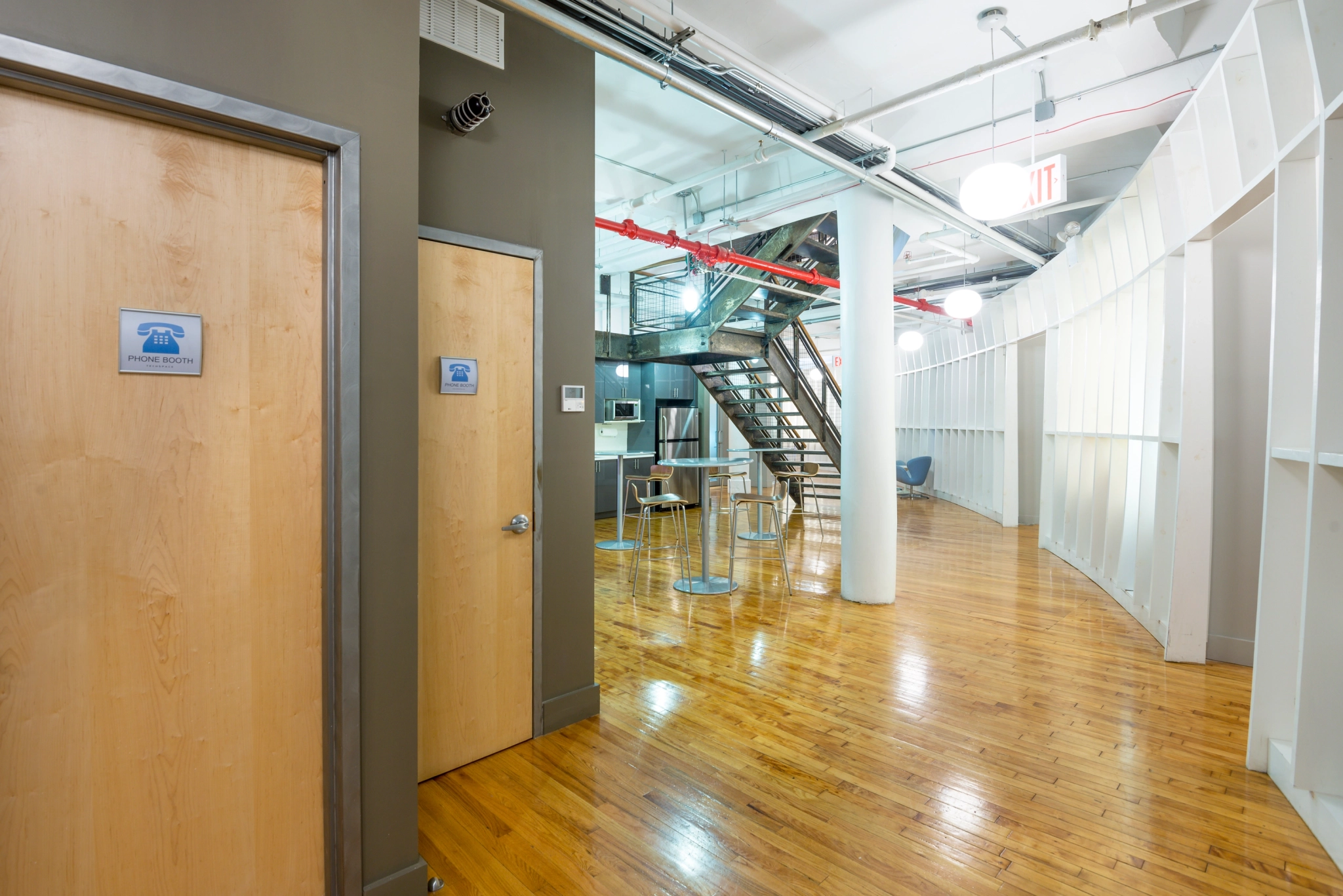 a workspace hallway in New York with a wooden floor.