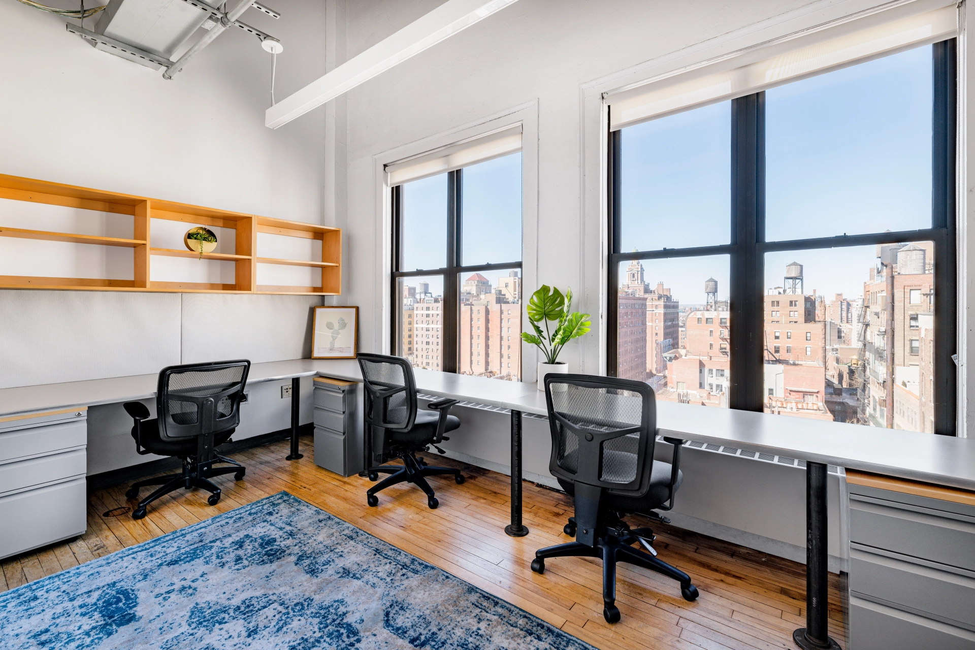 A New York coworking workspace with two desks and a window.
