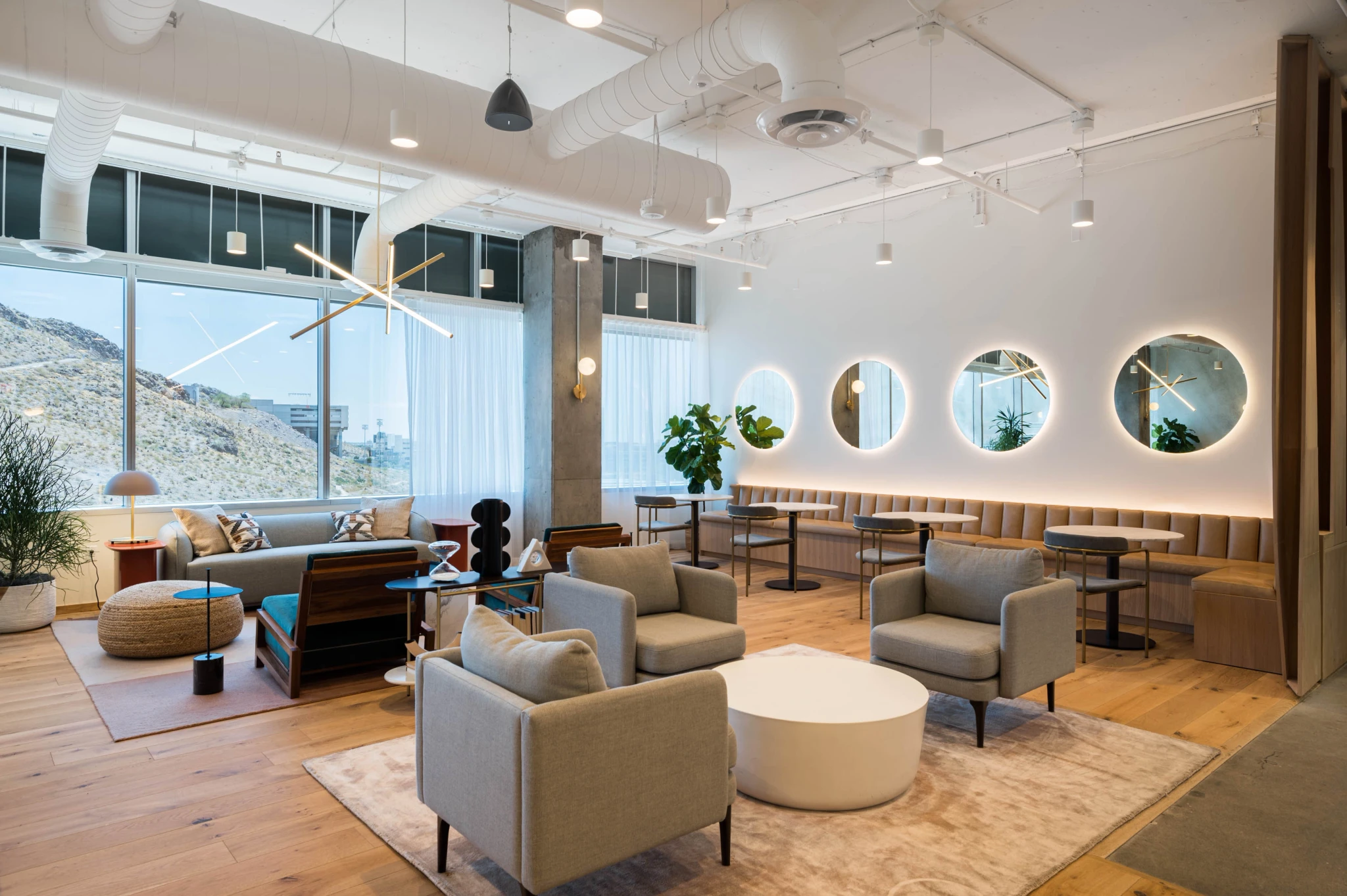 A modern office workspace in Tempe with wooden floors and large windows.