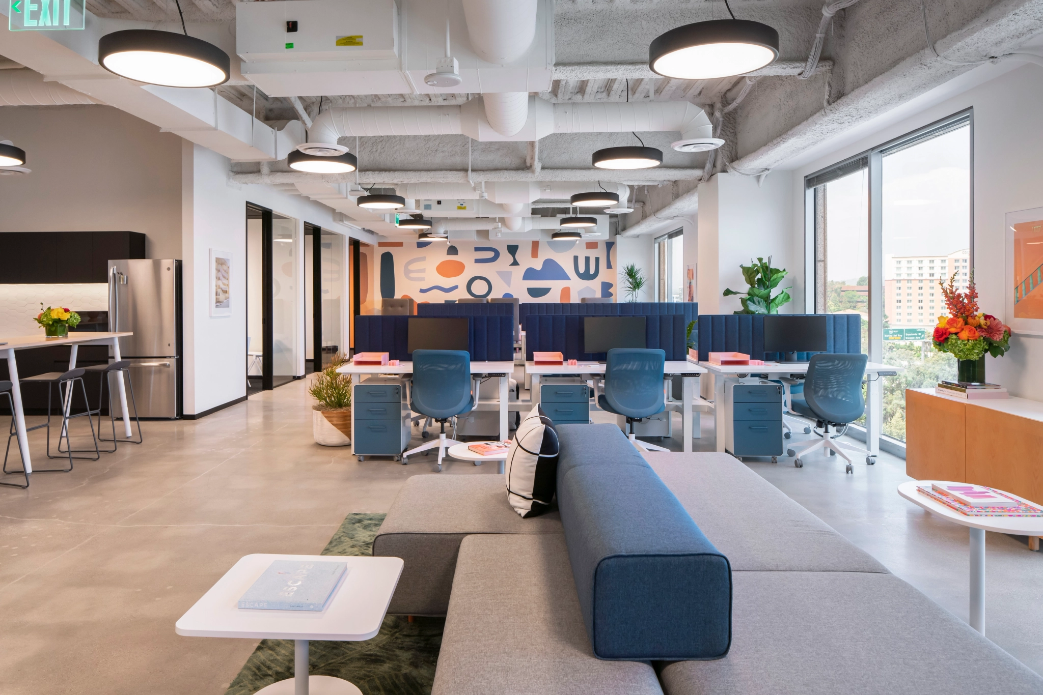 A modern Los Angeles workspace with blue and white furniture.