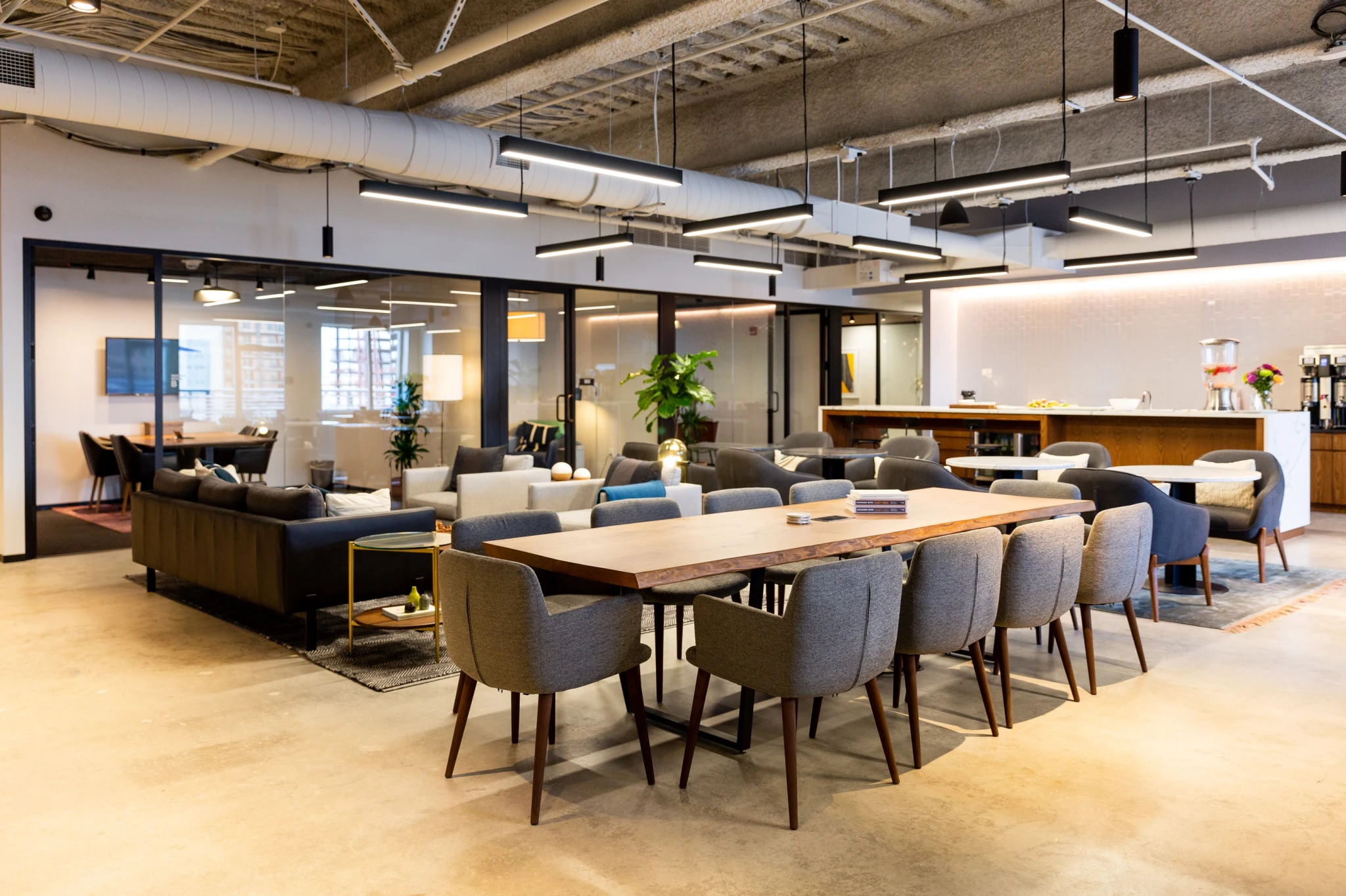 A modern meeting room equipped with a large table and chairs.