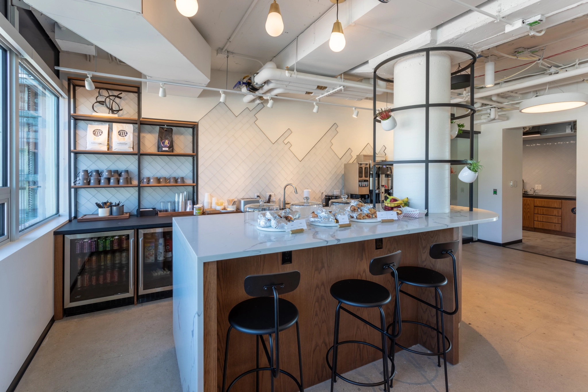 A coworking office in Boulder with a bar counter and stools.