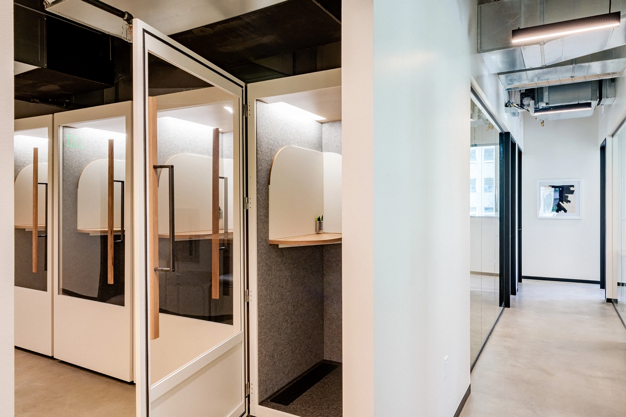 A glass-door hallway connecting workspaces in a Seattle office.