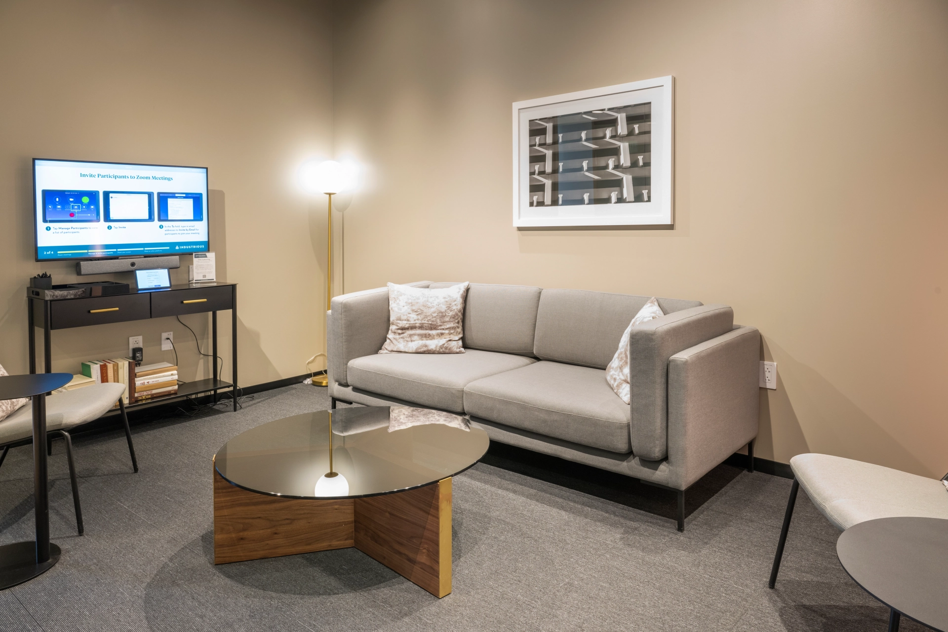 A coworking space with a couch, coffee table and TV.