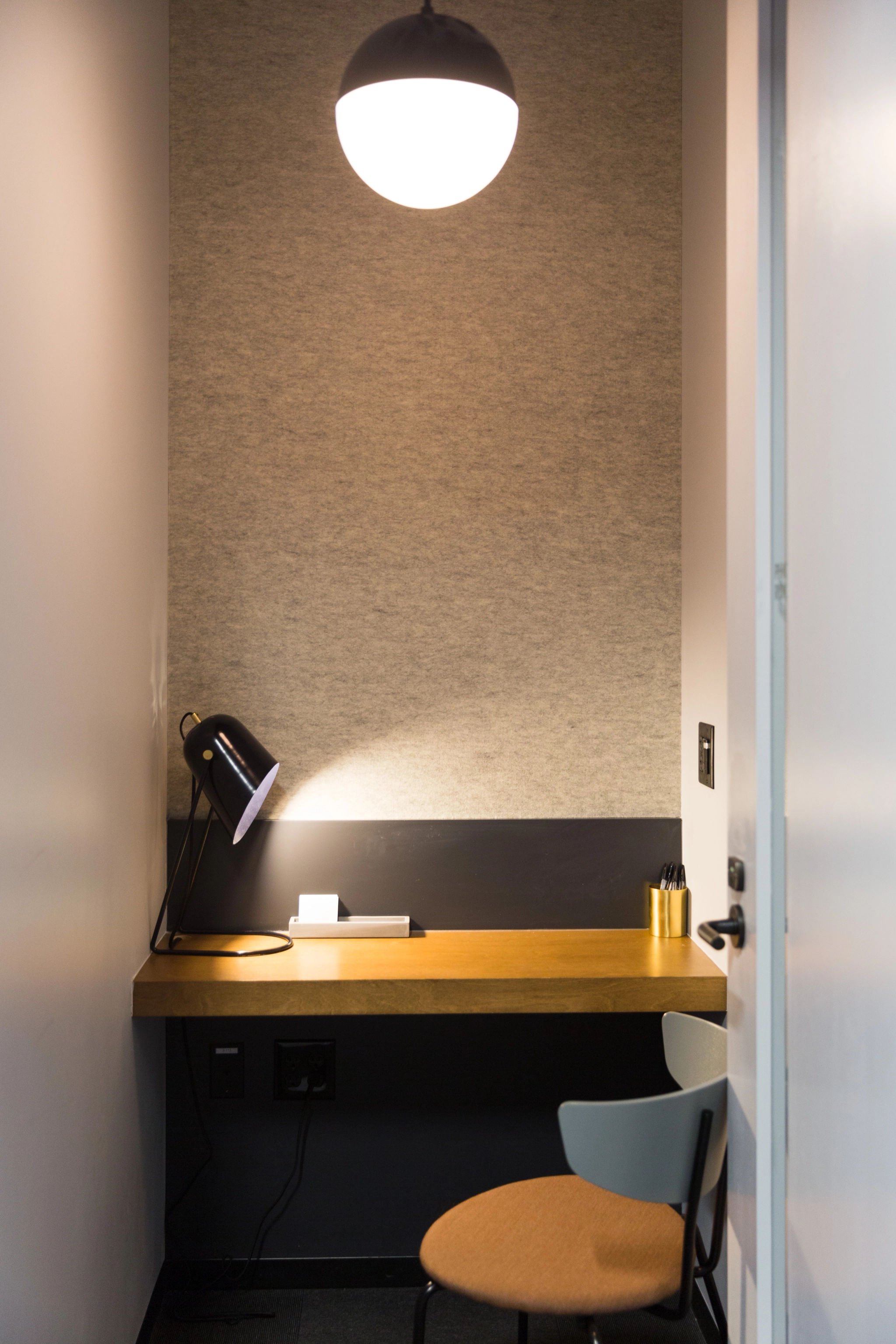 Coworking space in Indianapolis equipped with a desk, chair, and lamp.