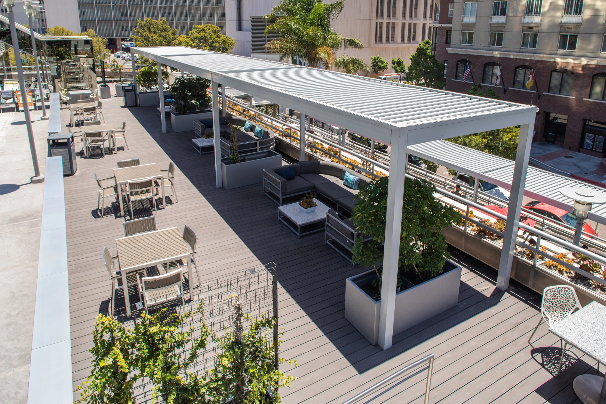 A rooftop patio with tables and chairs suitable for office coworking.