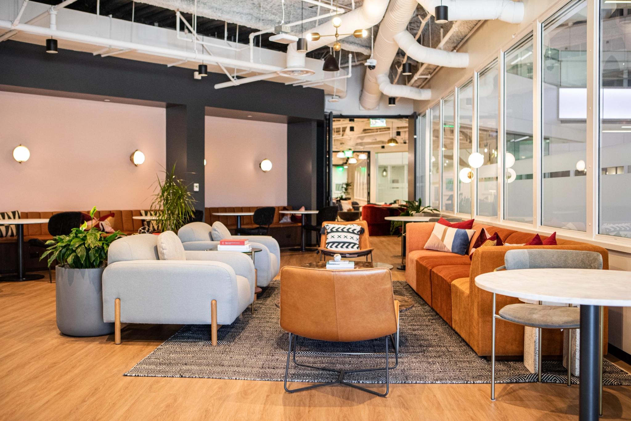 an open office workspace with couches and tables.