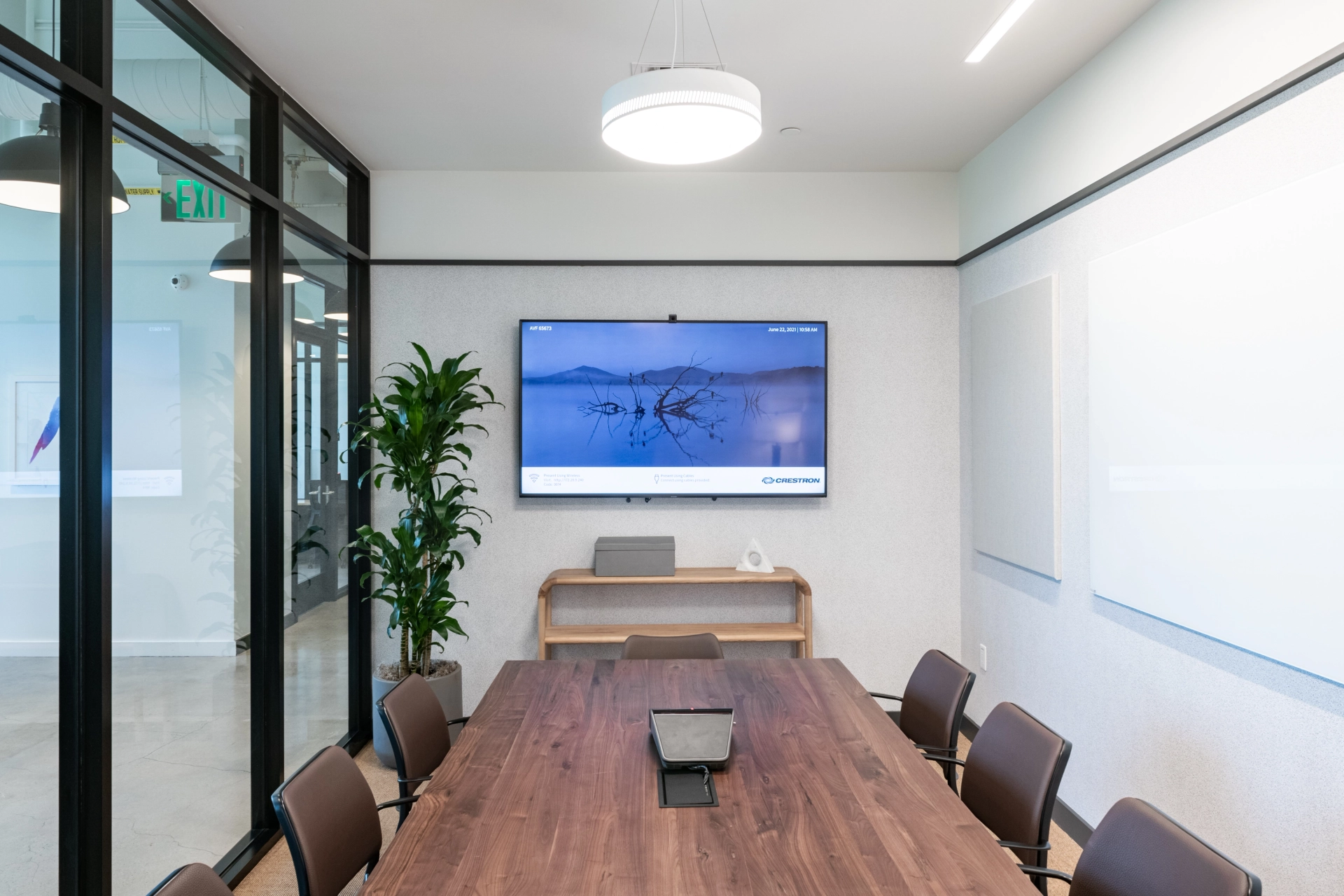 A Newport Beach coworking meeting room equipped with a TV on the wall.