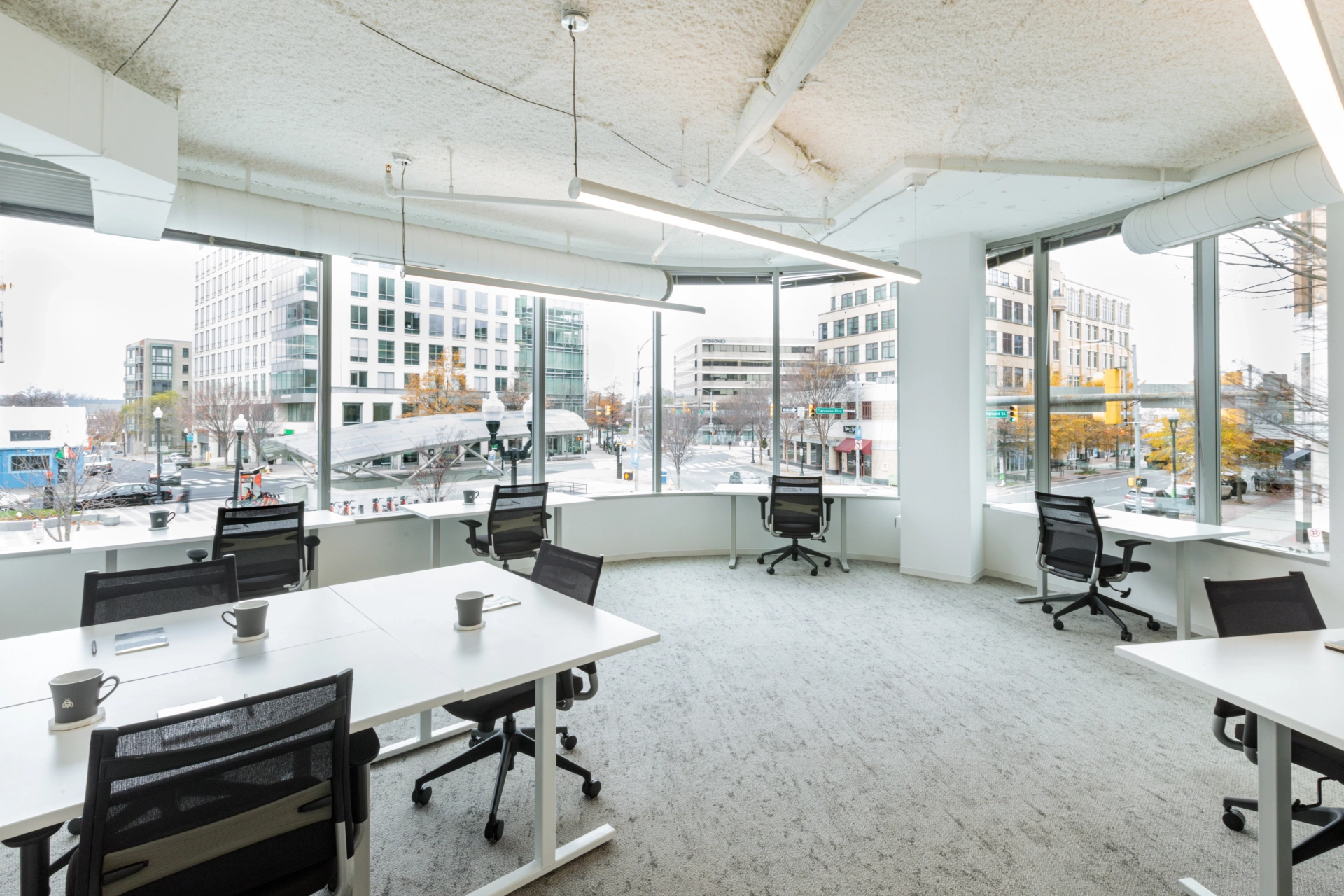 a spacious coworking office with numerous desks and chairs.