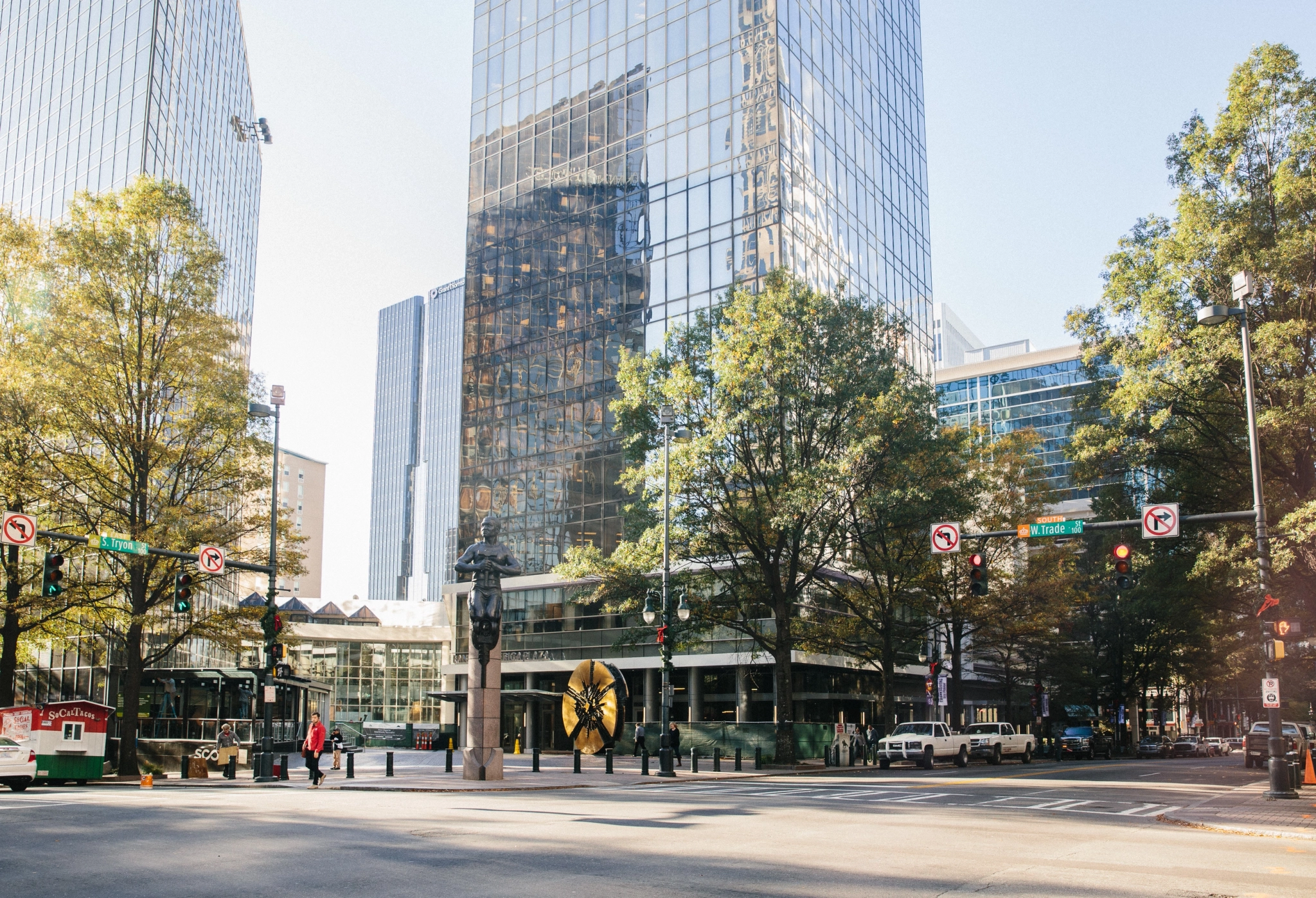 A city street with tall buildings and trees, transformed into a vibrant office workspace.