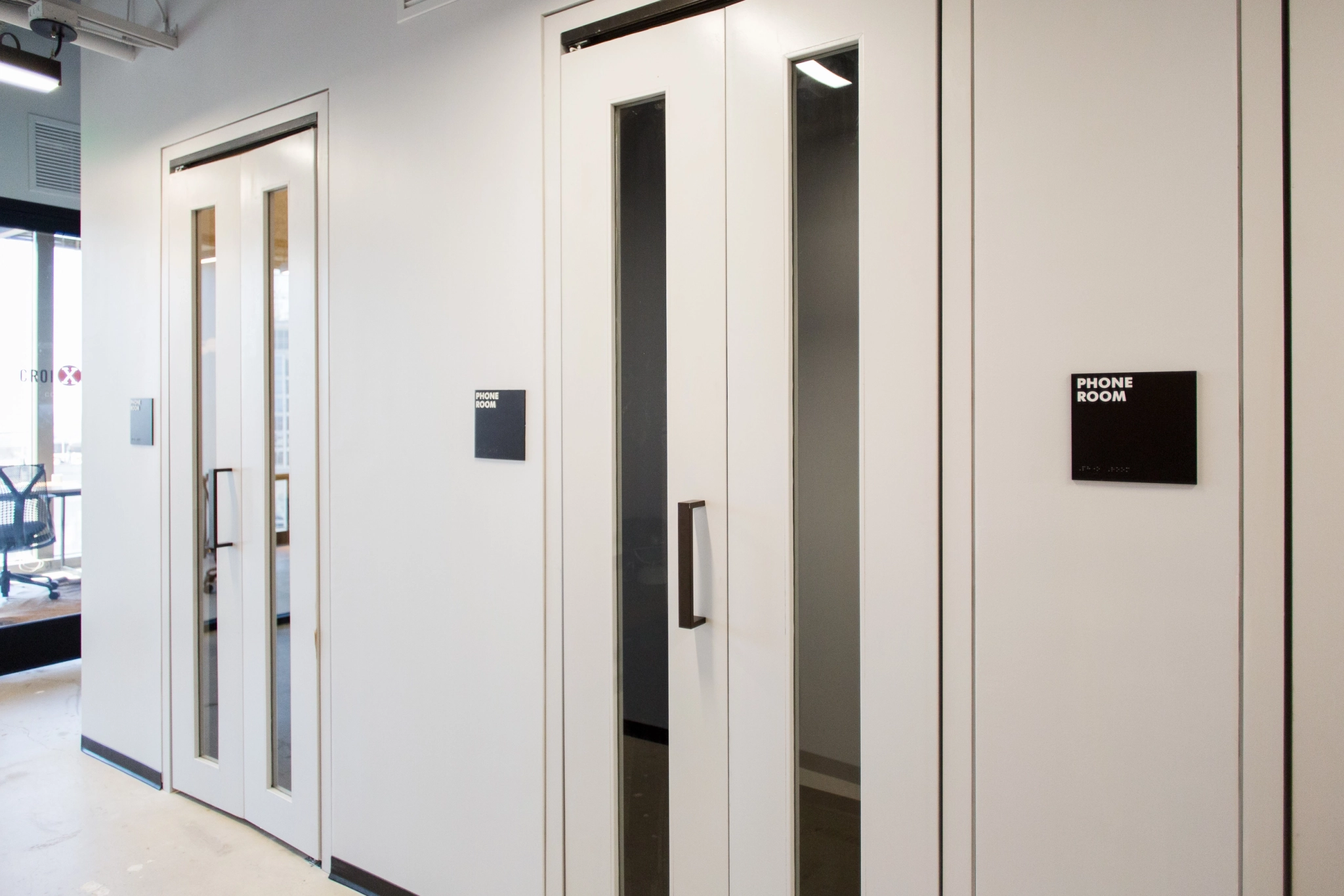 a coworking office in Charlotte with a glass meeting room door.