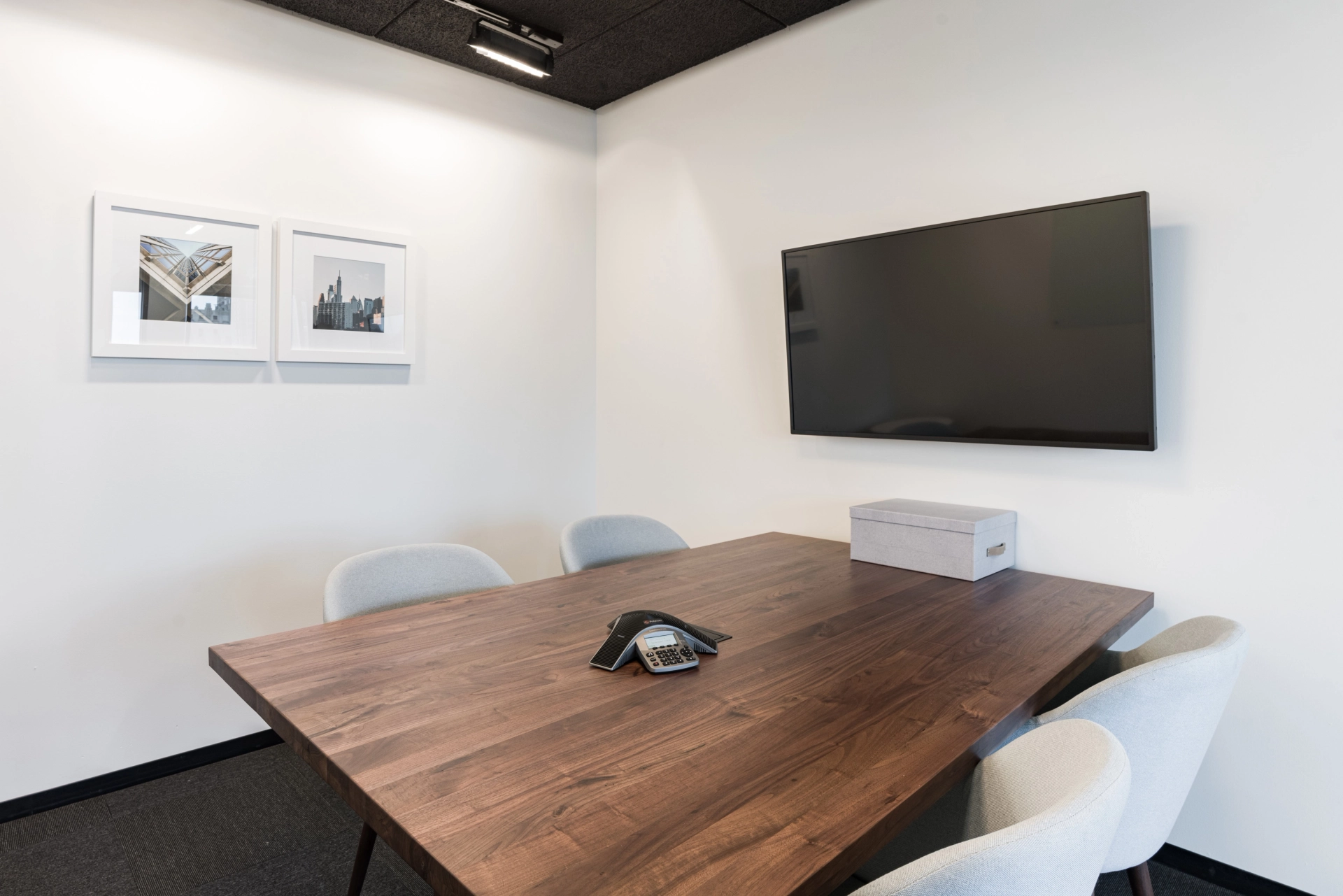 A Philadelphia office workspace equipped with a conference room complete with a table, chairs, and a TV.