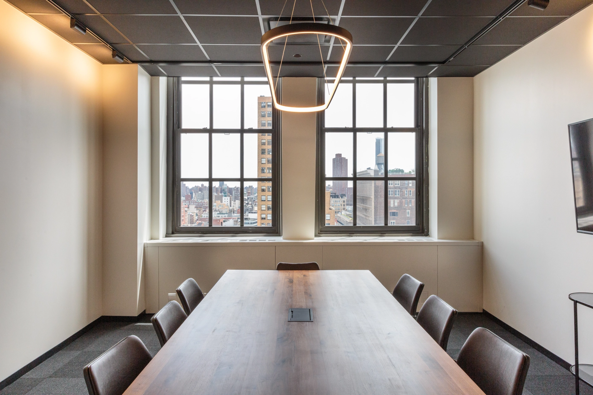 A coworking office space equipped with a spacious conference room featuring a large table and chairs.