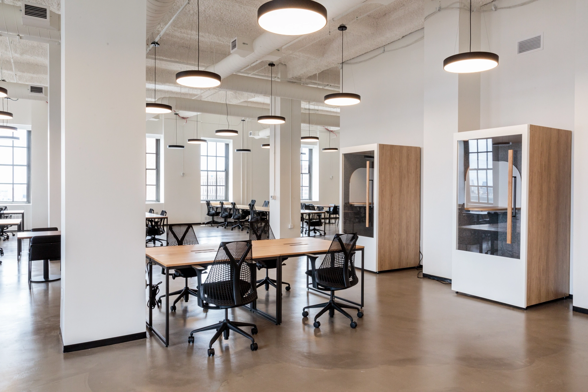 a spacious coworking office with tables and chairs.