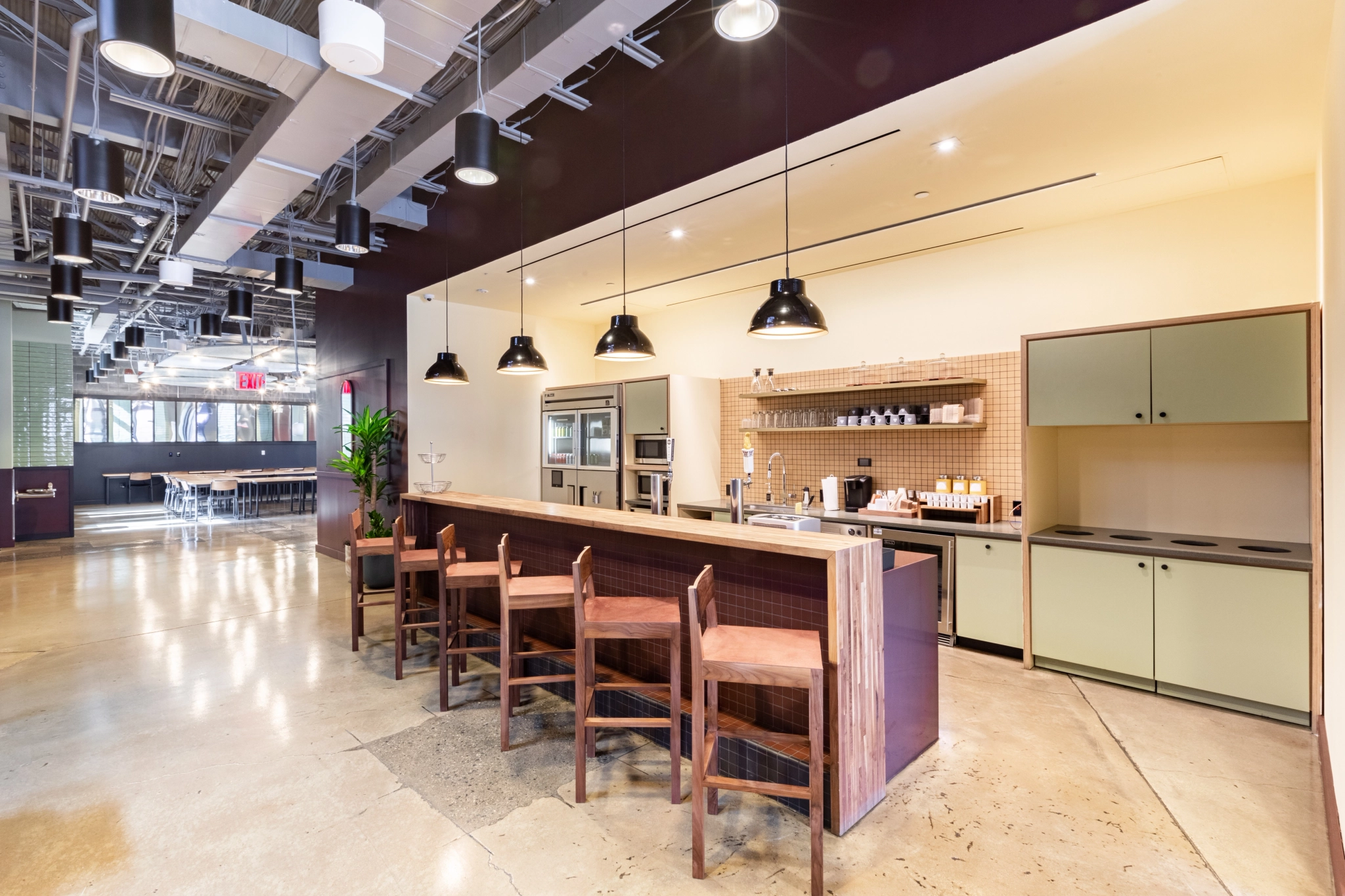 A contemporary workspace with a bar and stools.