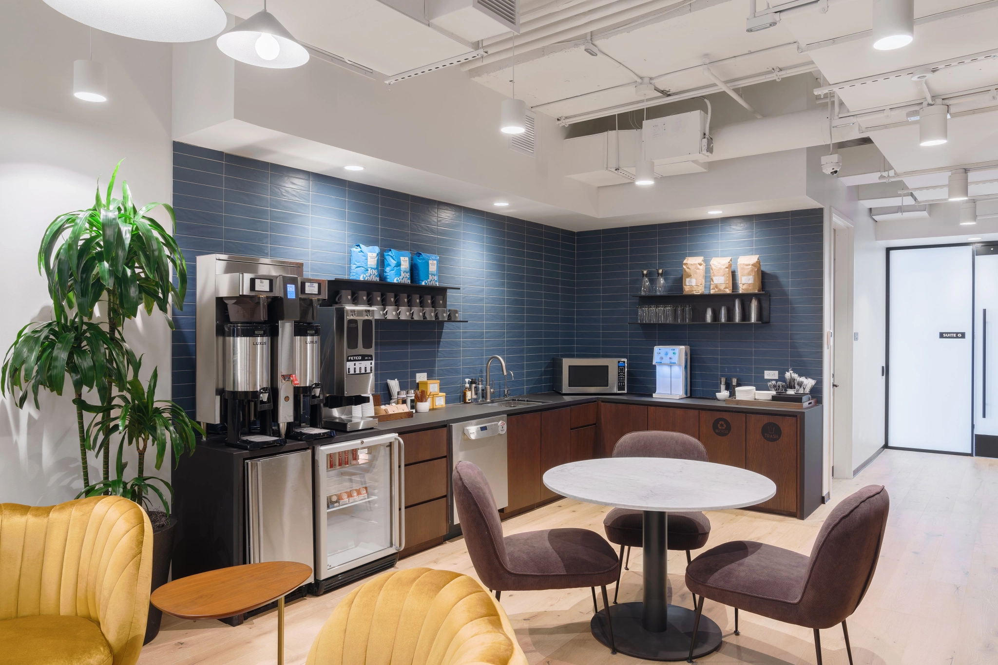 A coffee shop serving as a workspace for office professionals, equipped with a table and chairs for meetings.