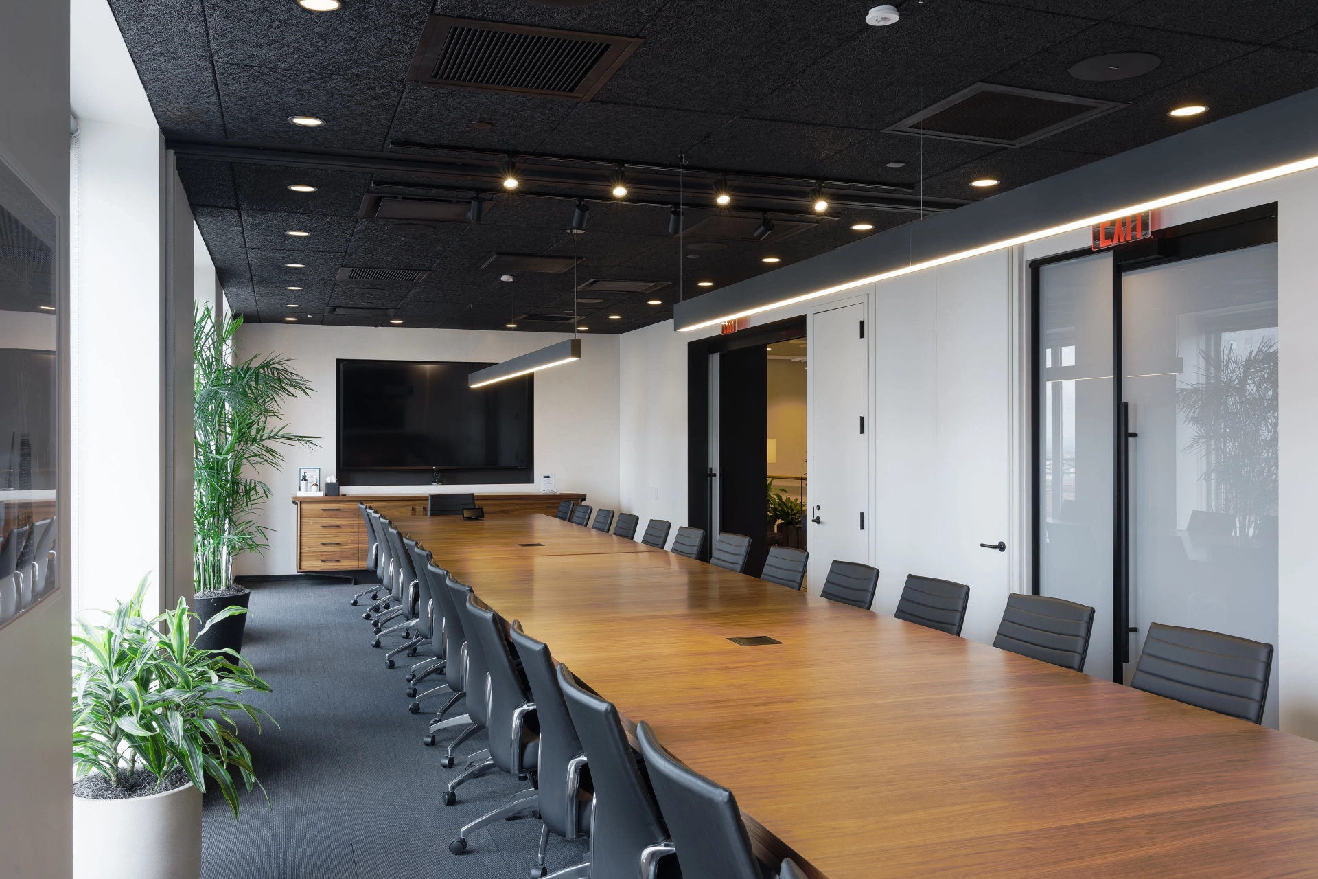 An office meeting room in New York furnished with a long table and chairs.