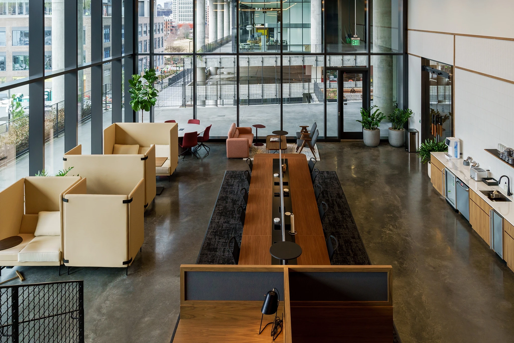 A modern open-concept office in Atlanta with large windows and wooden furniture.
