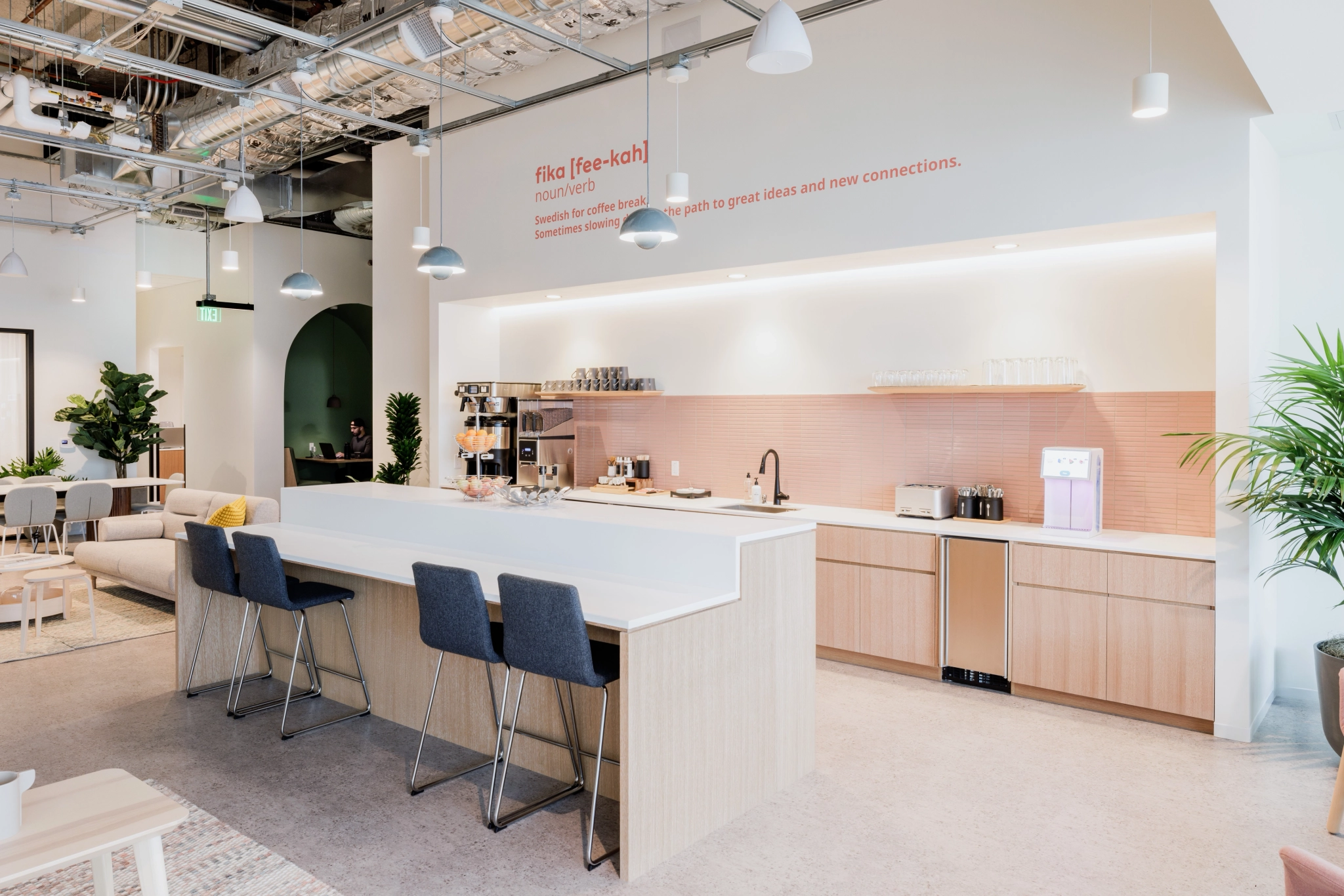 A modern office in San Francisco with an open kitchen and dining area that doubles as a meeting room.