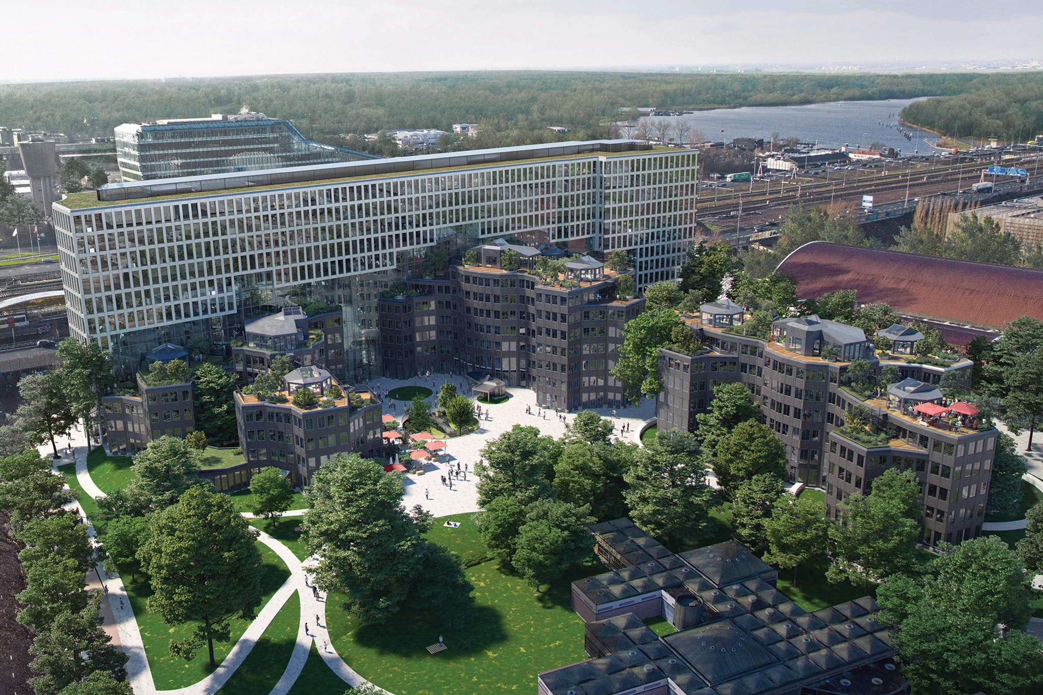 An aerial view of an office building in Amsterdam, surrounded by trees.