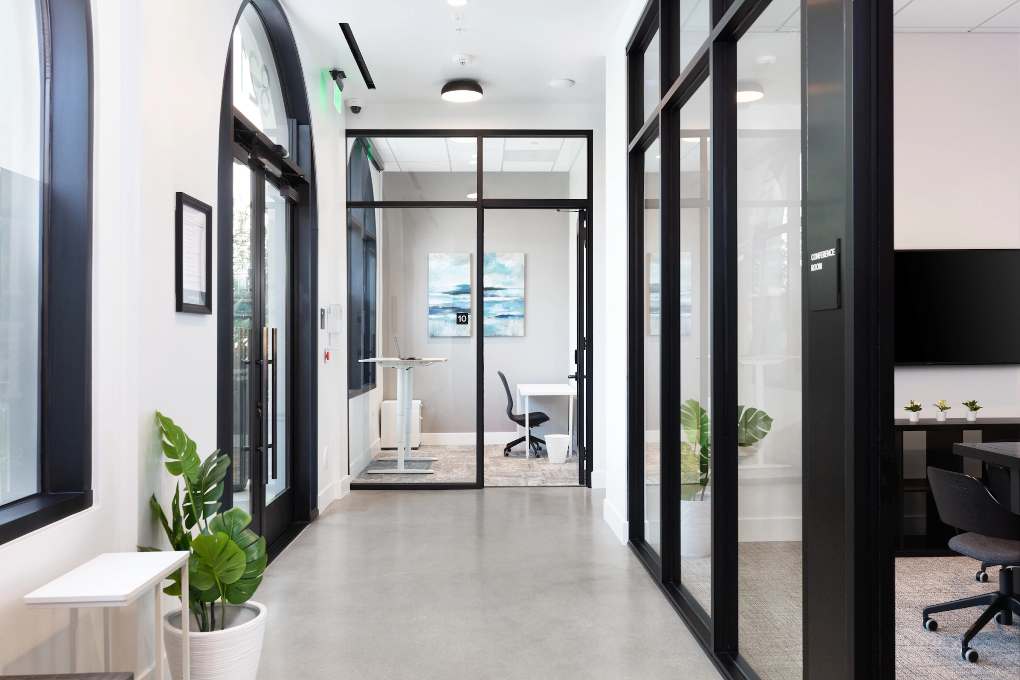 A modern office with glass doors and a TV, located in Brea.